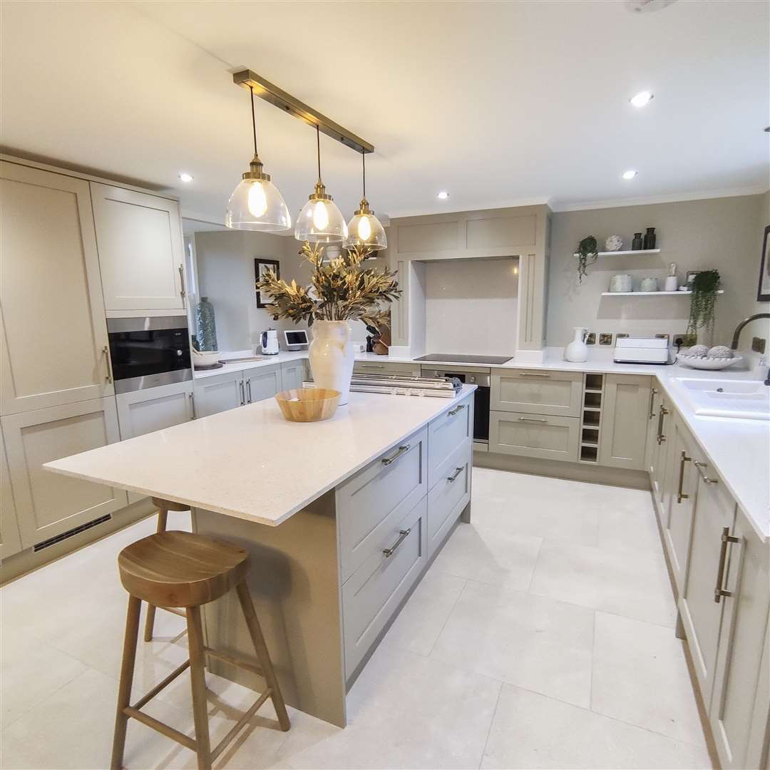 The stunning fully-fitted quartz kitchen has a large island unit.