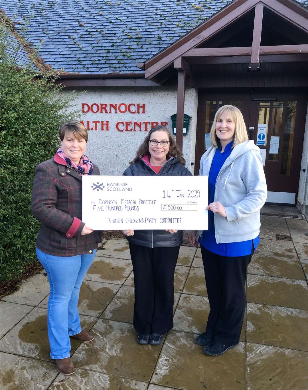 Dr Elizabeth Campbell (centre) of Dornoch Medical Practice was presented with the £500 cheque by children’s party committee treasurer Tiffany Fraser (left) and secretary Julie Ross.