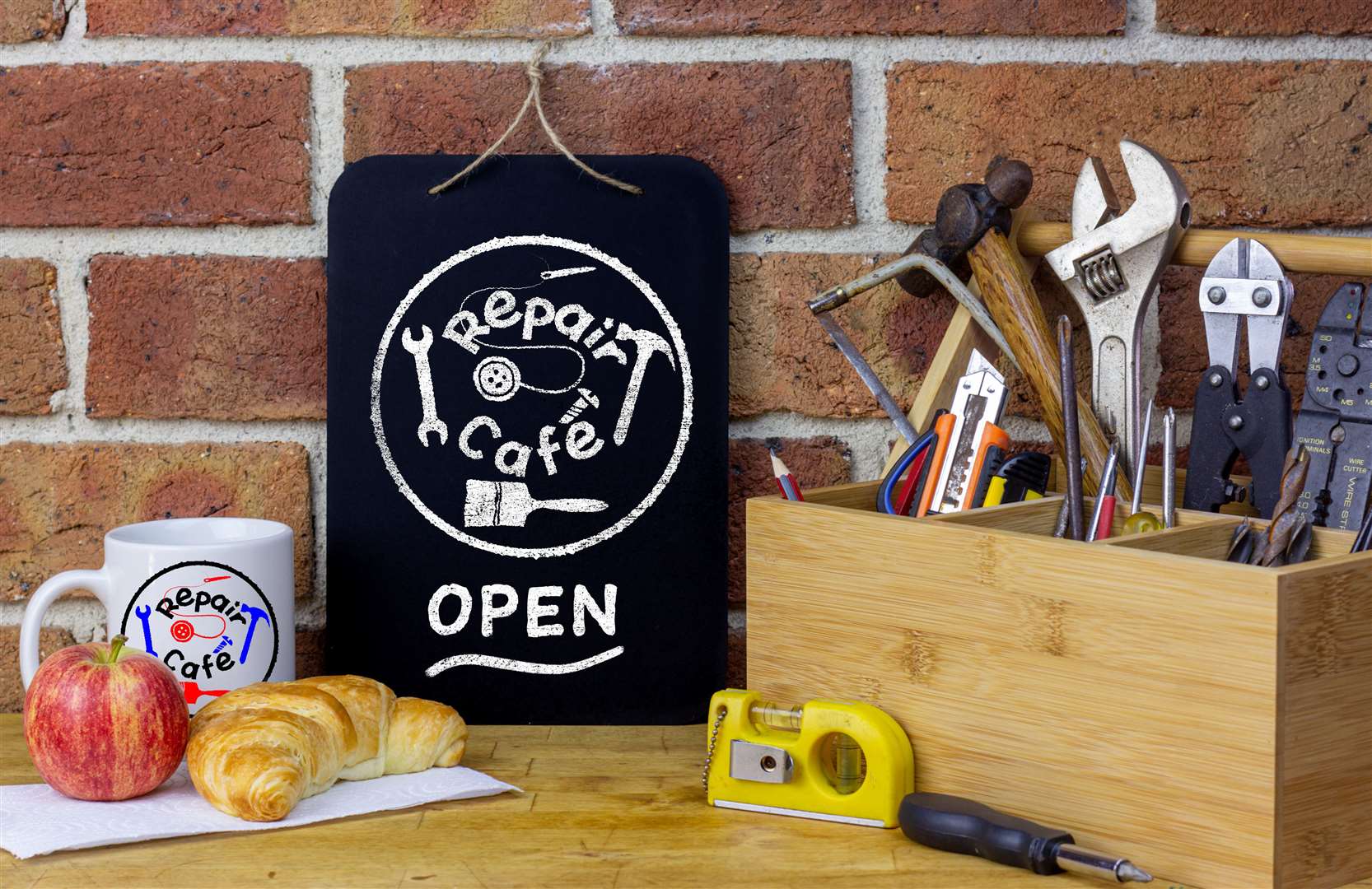 A Repair Cafe is where people meet together with the aim of repairing objects used in everyday life and prevent items going to landfill. Stock Image