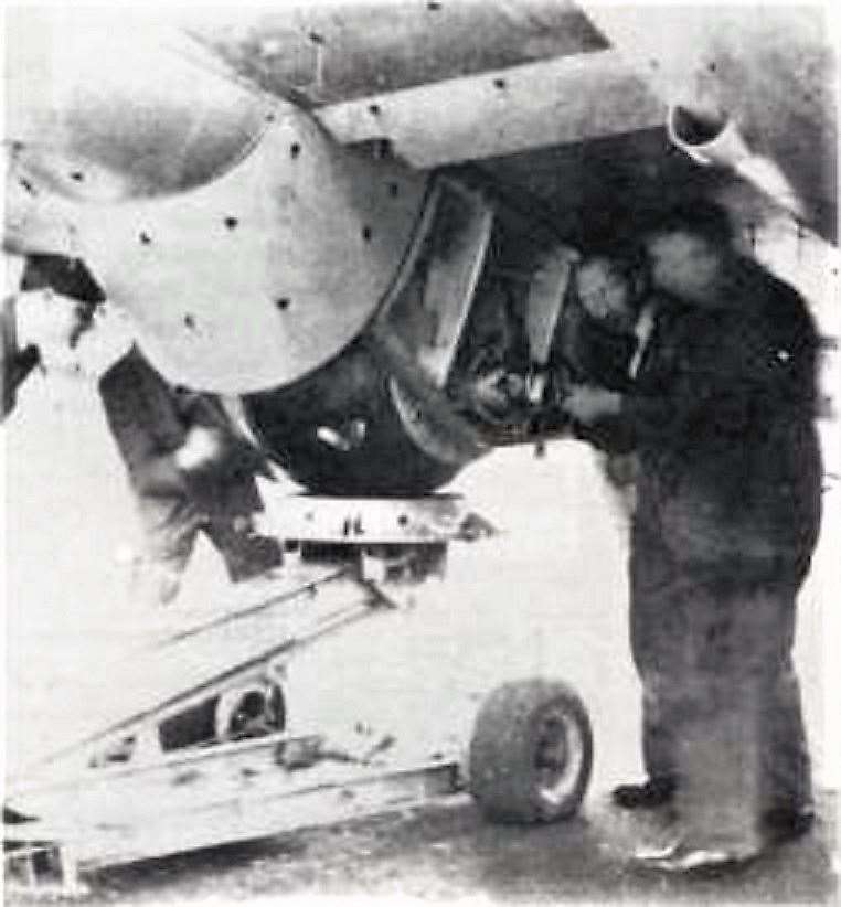 The bombs being fitted within an aircraft.