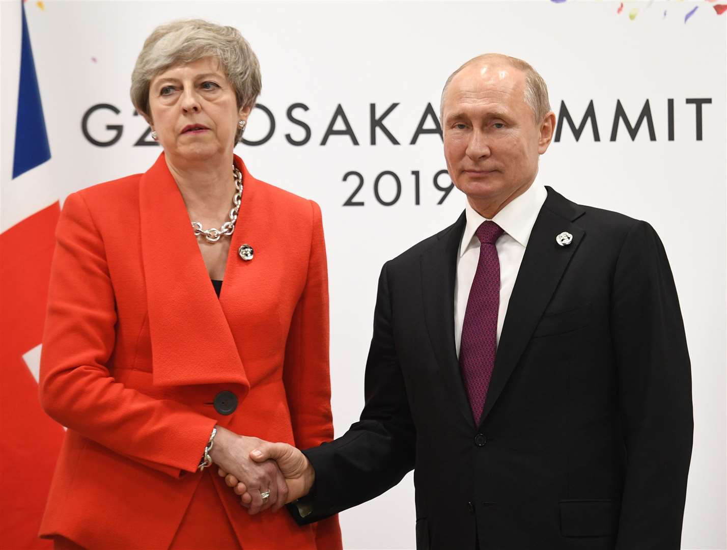 Theresa May shakes hands with Russian president Vladimir Putin (Stefan Rousseau/PA)