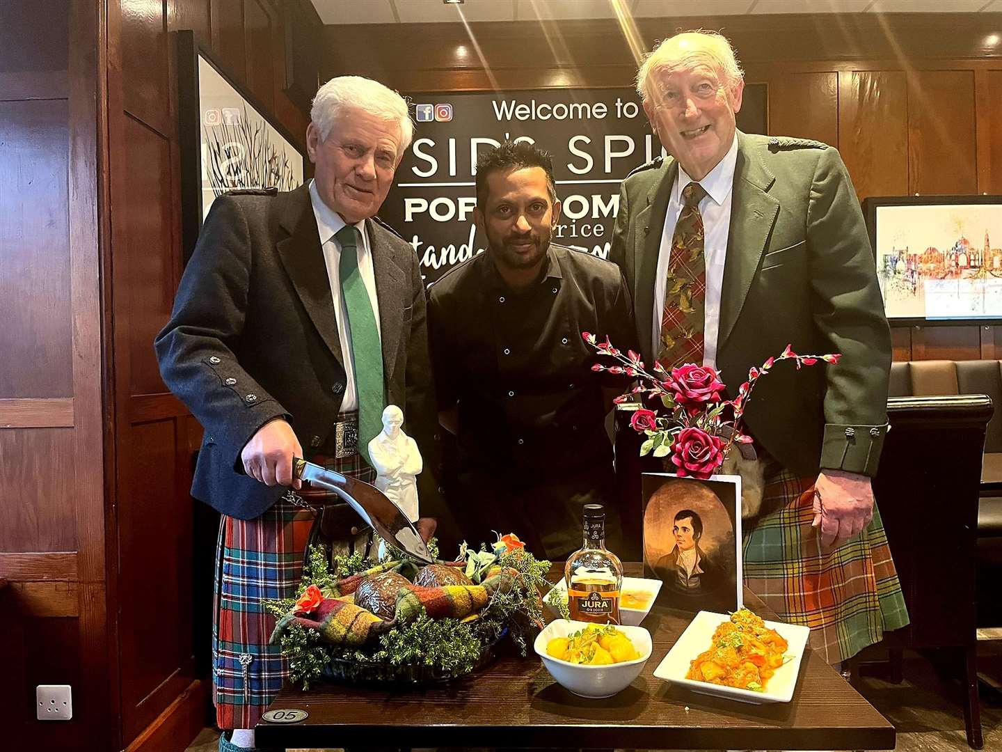 Alisdair Miller (left) addresses the haggis pakoras – and the curry! – as Alistair Risk and Sid look on.