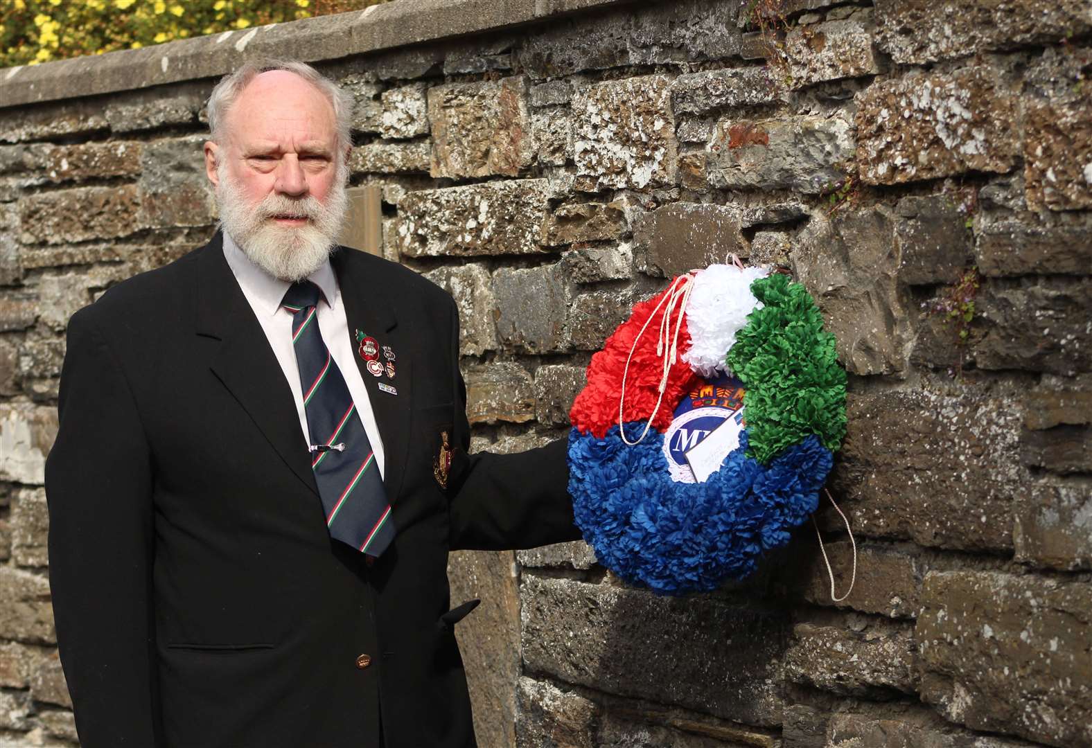 Mike Coupland, secretary of the Caithness branch of the Merchant Navy Association, was among those who lit candles at a memorial service in a Wick church. Picture: Alan Hendry