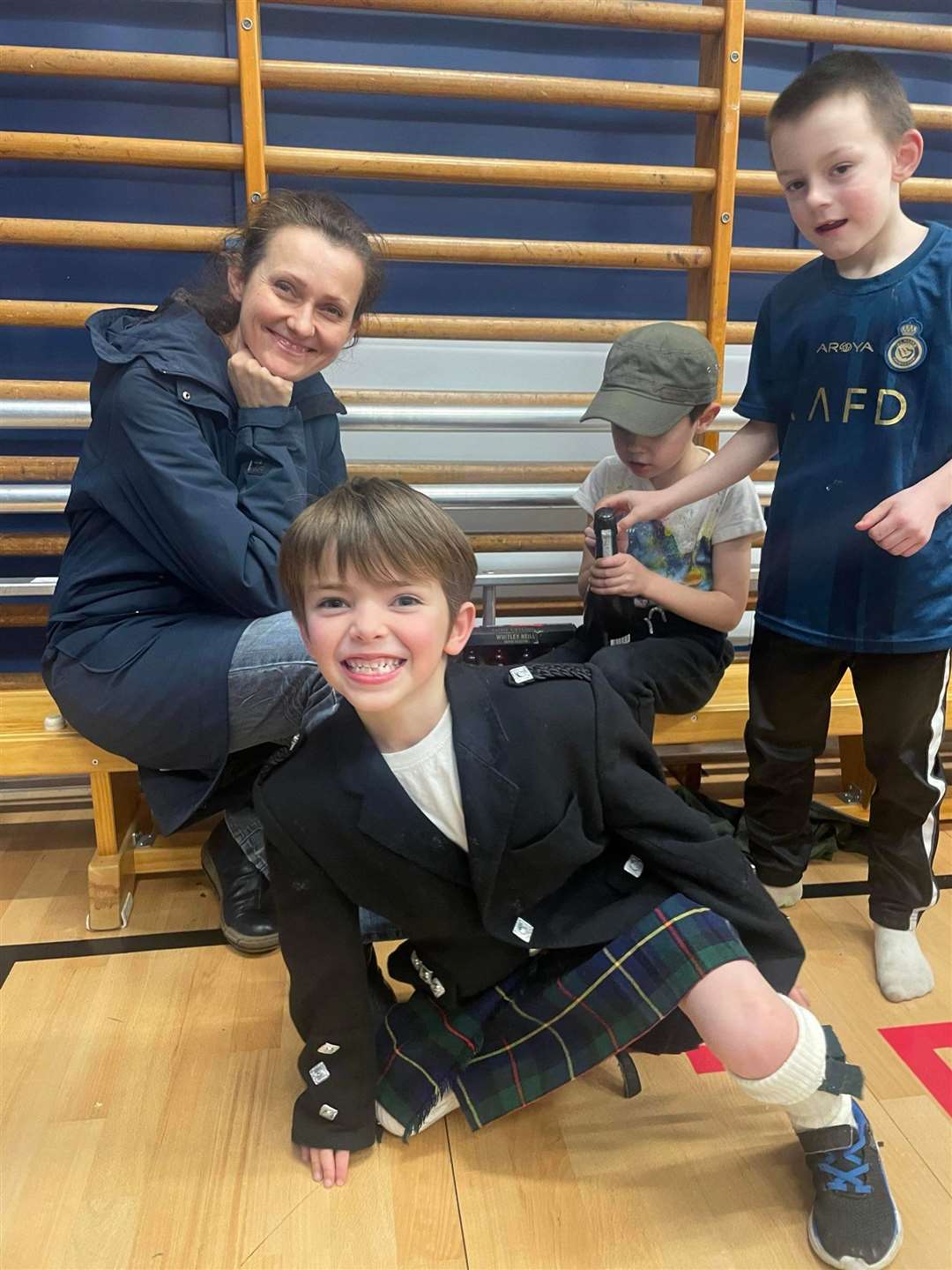 A kilted Conall Withey with Ulla and Liam Henderson and Archie Bain.