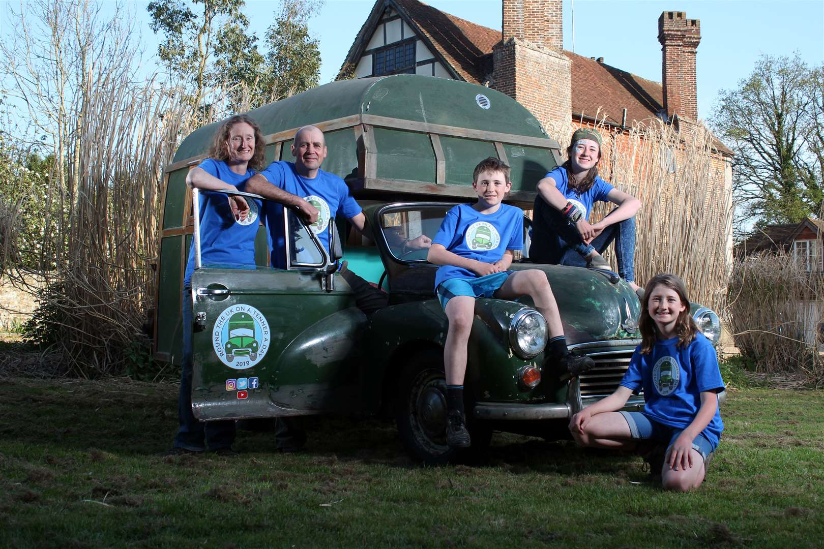 The Chick family perched on their vintage campervan.