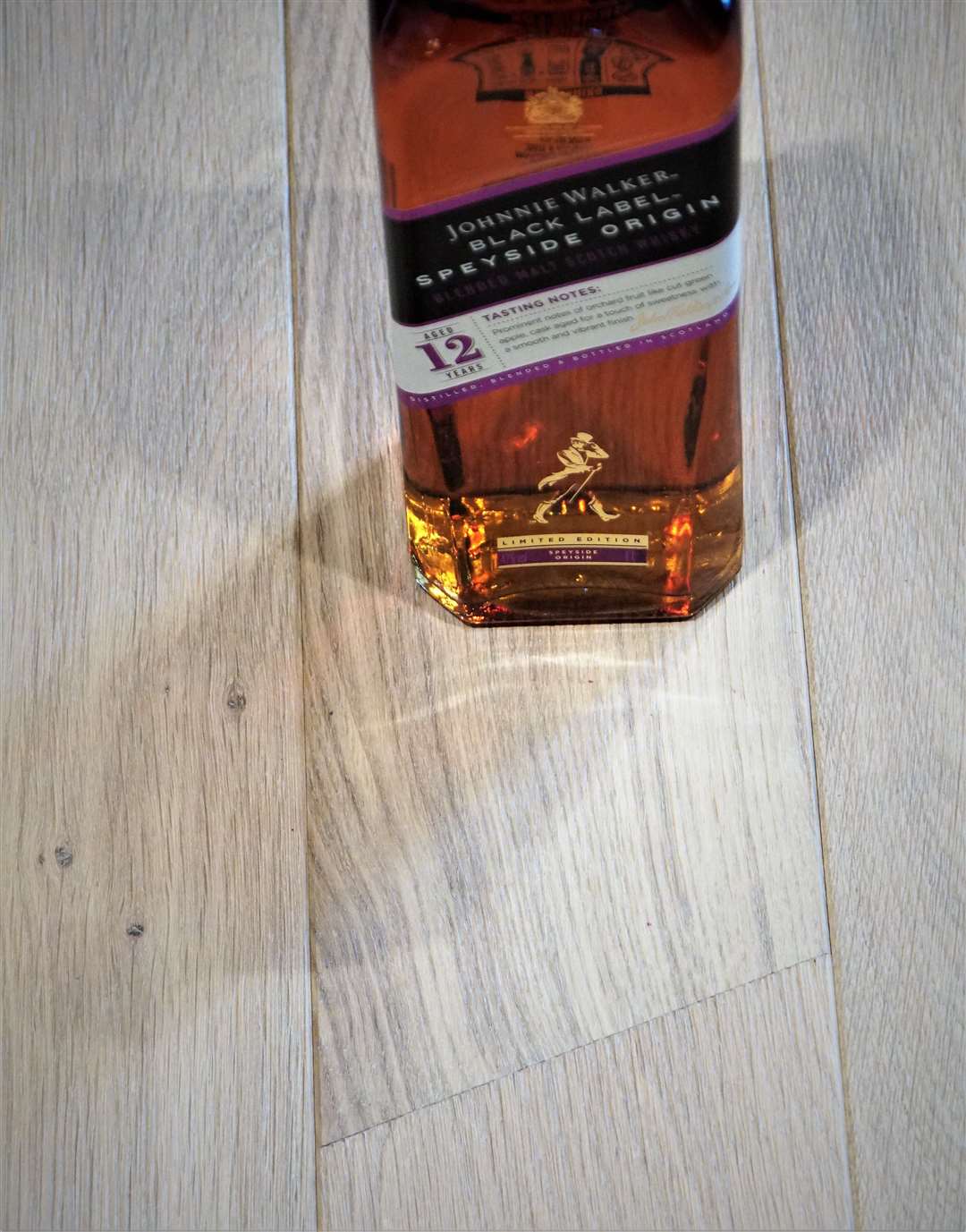 The angle of the whisky label perfectly matches the angled cut of the flooring panels.