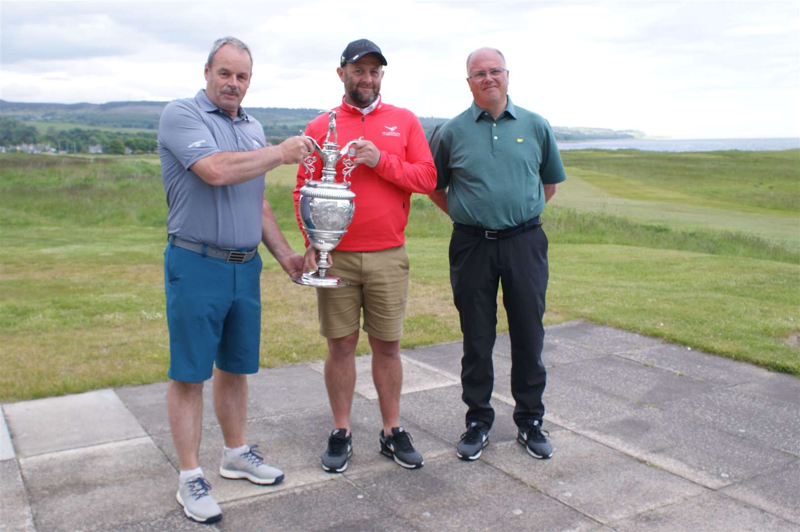 Christopher Mailley receiving the trophy from Golspie GC Captain William Macbeath with runner-up Roddy Cameron in attendance. This is the eighth occasion on which Christopher Mailley has won the championship.