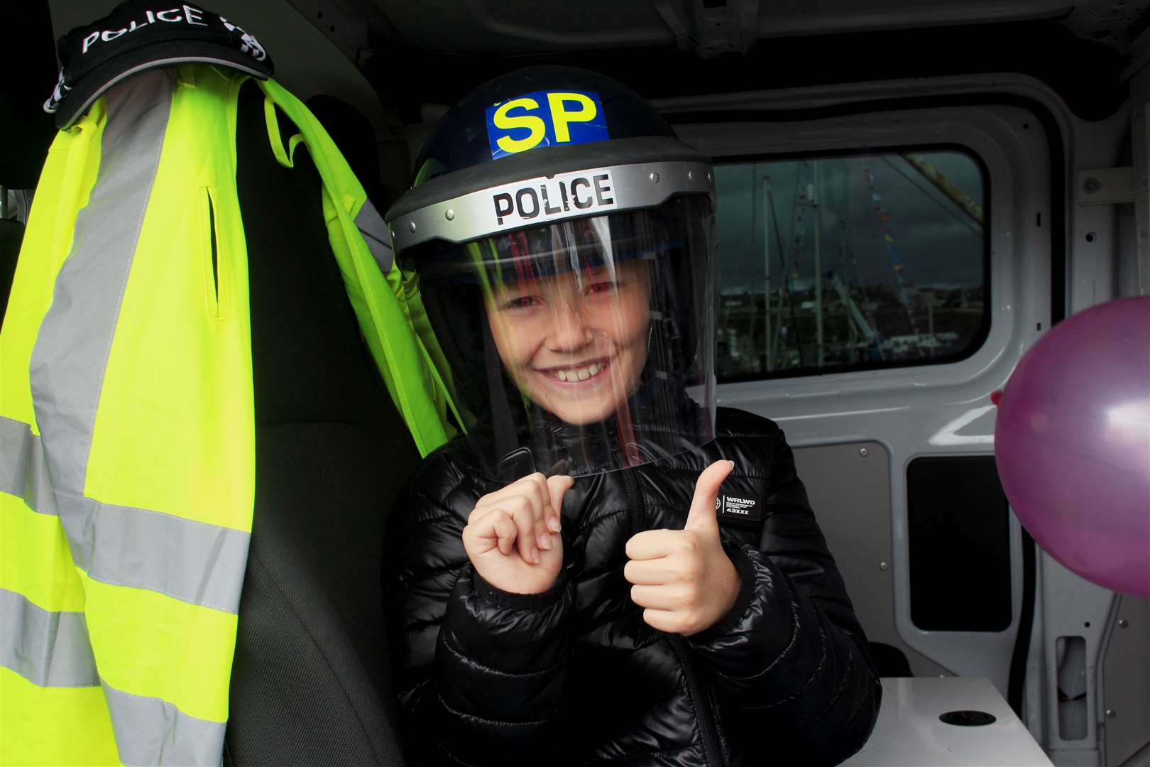 James Cowie (9), from Wick, was delighted to get a look inside a police van. Picture: Alan Hendry