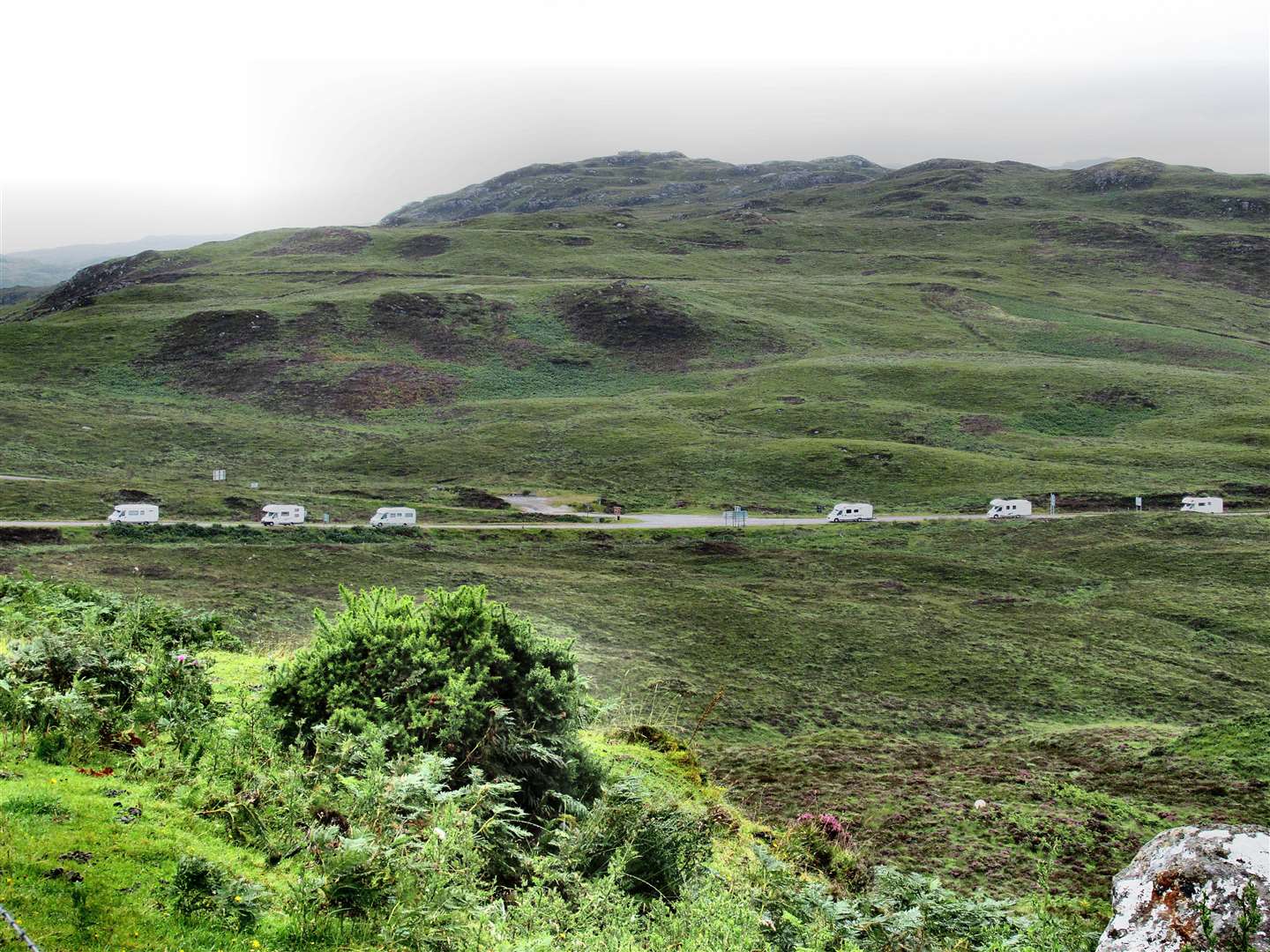 Six motor homes travel within a short distance of each other on a section of NC500.