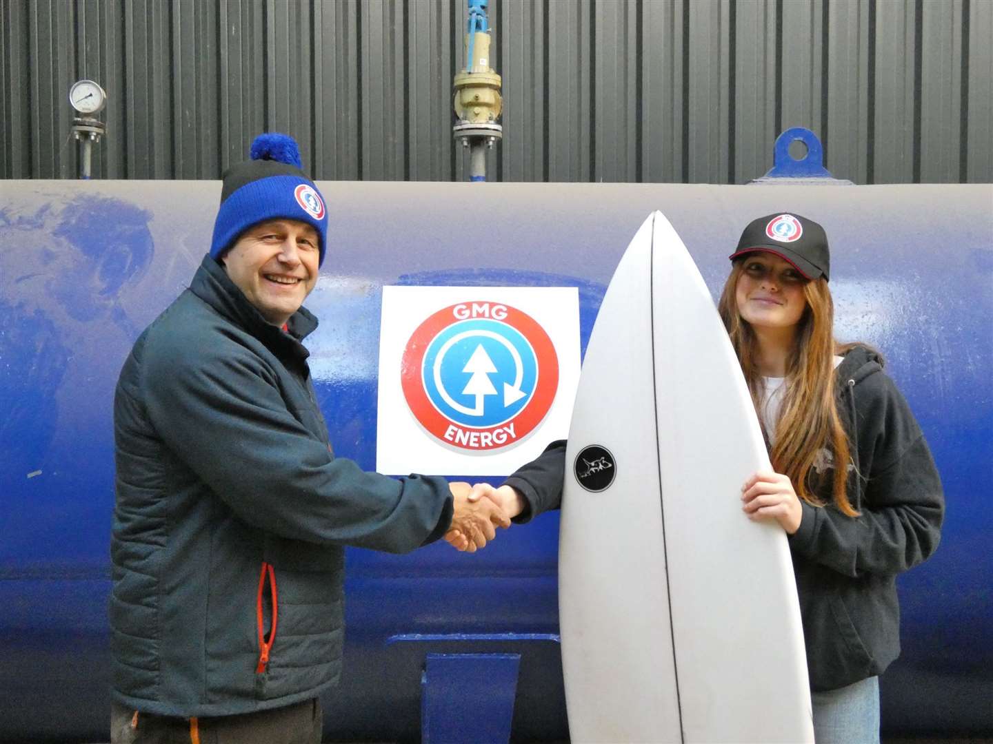 Olivia Mackay shakes hands with GMG Energy director Malcolm Morrison who, along with another local business, is supporting her bid for surfing success at the world junior championships.