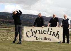 Jim Miller driving off at the new hole, watched by head greenkeeper James Macbeath, Jim Casey from Clynelish Distillery and club president Alistair Risk.