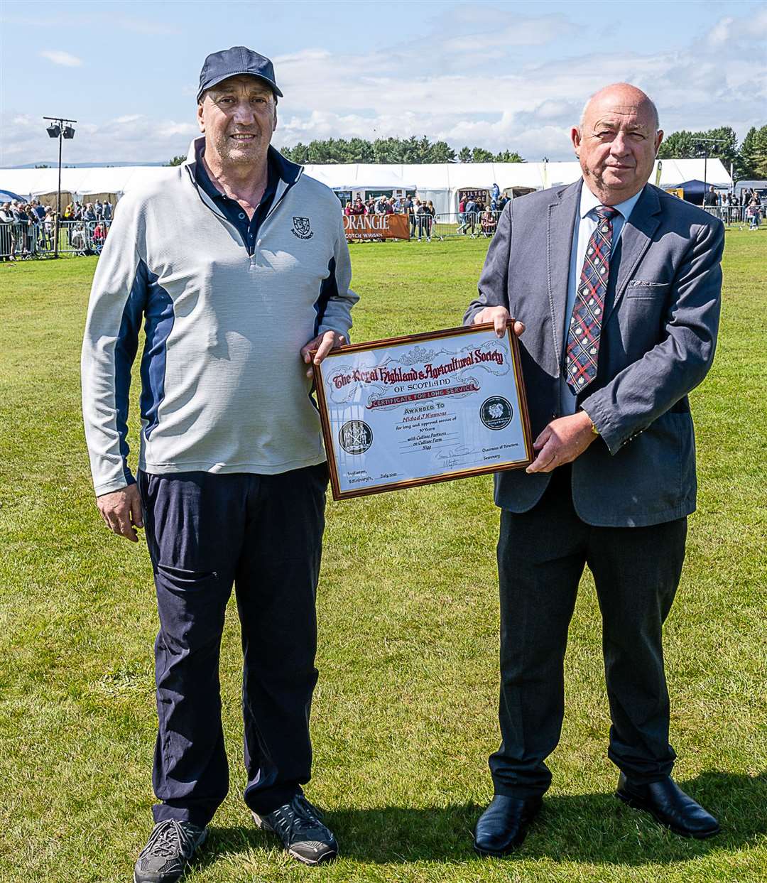 Special award to Michael Nimmons (left) for 31 years of service at Cullisse Farm, Nigg presented by Dennis Bridgeford, director Royal Highland & Agricultural Society. Photo: East Sutherland Camera Club