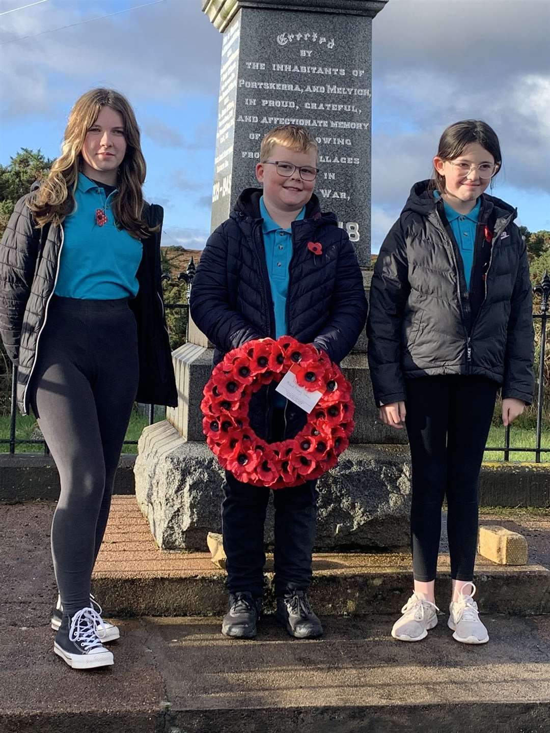 The school's house captains (from left) Kamryn Mackay, Matthew MacKintosh and Emily Farquhar laid a wreath in memory of those who died in the service of their country.