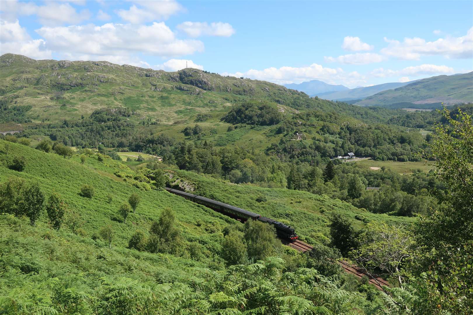 The Jacobite train approaches Glenfinnan station.
