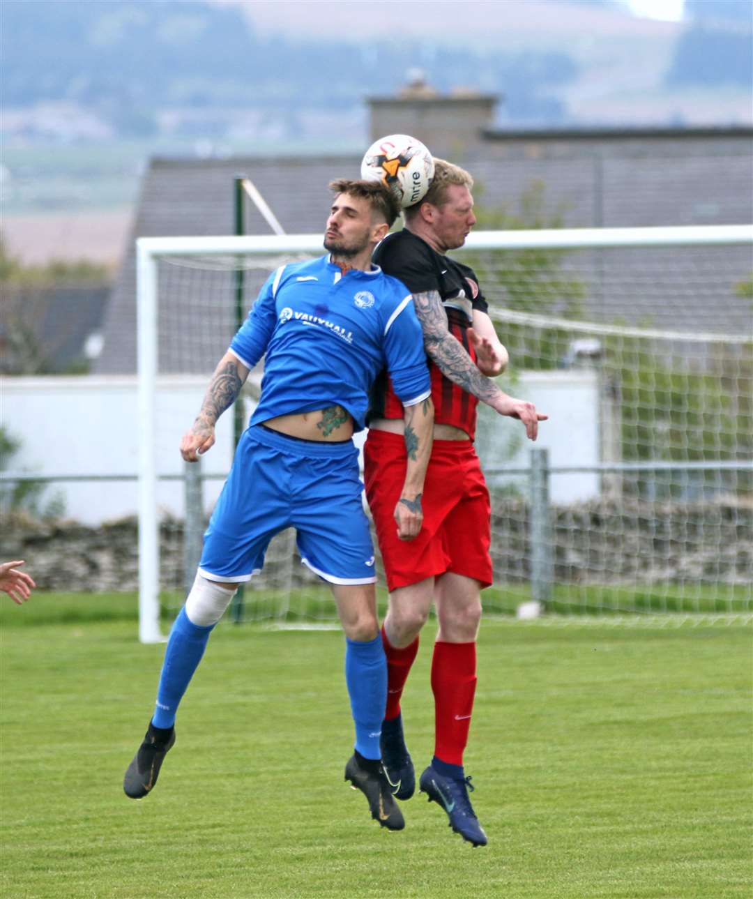 Golspie's Liam Bremner and Halkirk United's Aiden Reid compete for a high ball. Picture: James Gunn
