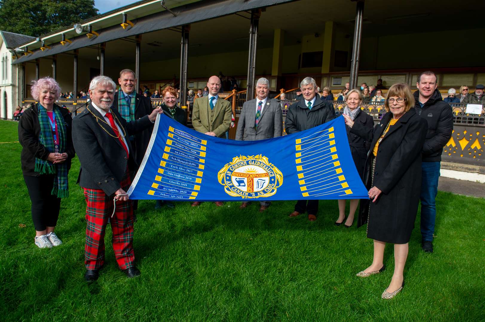 Depute Provost Cllr Bet McAllister (right) hands over the flag to Perth and Kinross Provost Dennis Melloy (left) at the conclusion of this year's Royal National Mod in Inverness. Picture: Callum Mackay