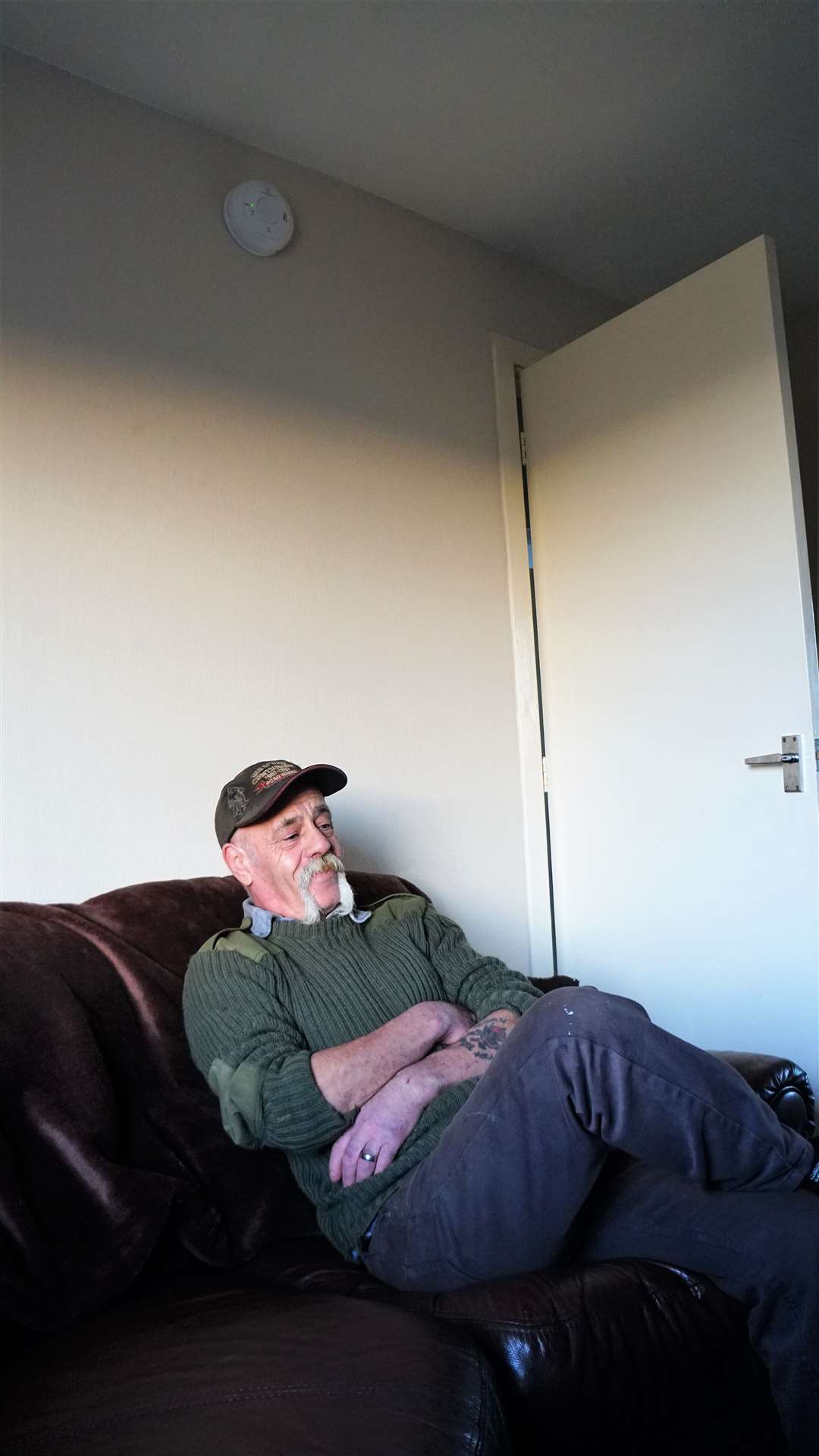Davie Nicolson in his sitting room. The carbon monoxide detector above his head awoke him and his wife when fumes filled the house. Picture: DGS