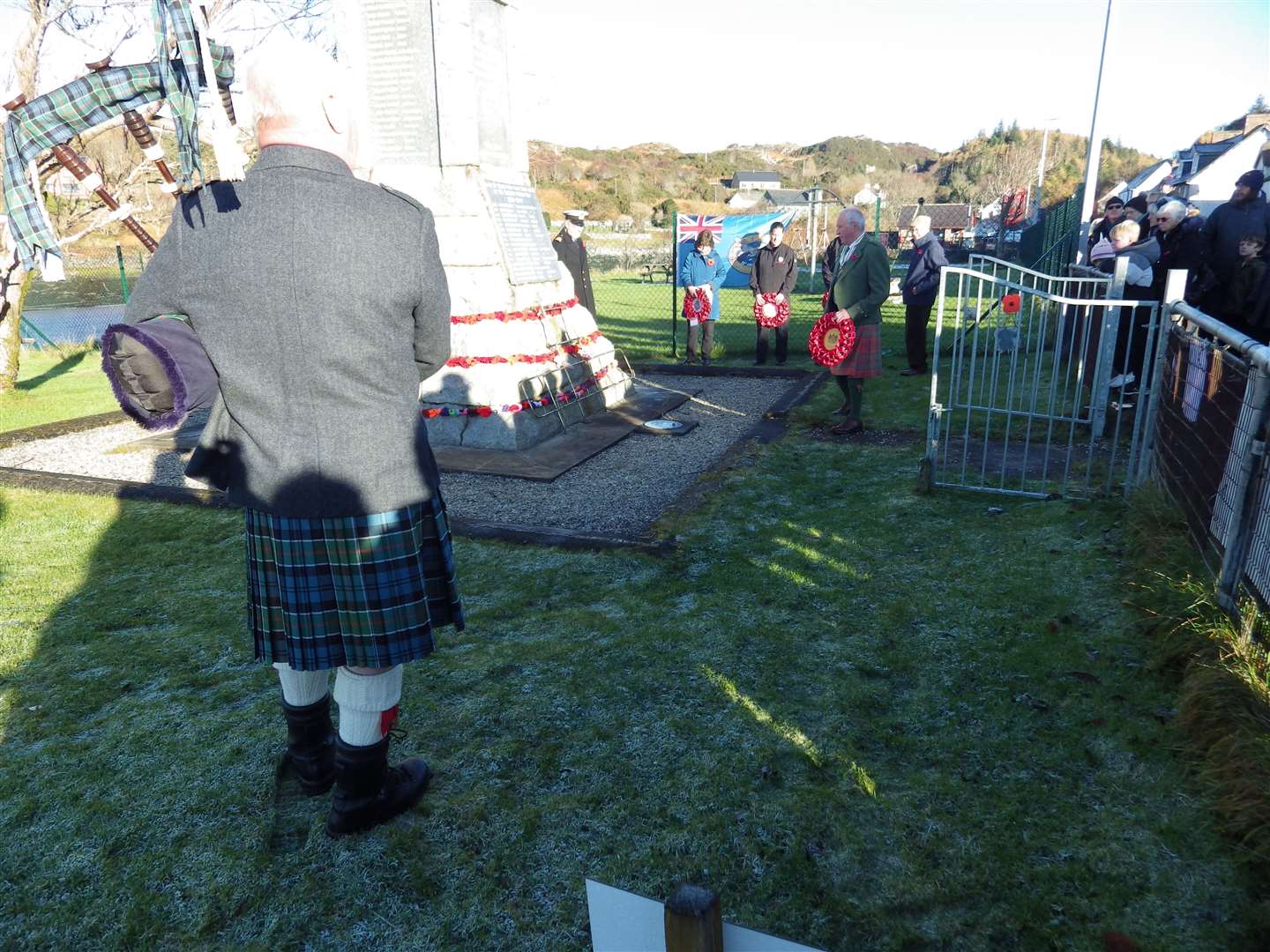 Charlie Cowan pipes while retiring Deputy Lieutenant David Grant lays the wreath on behalf of Sutherland Lord-Lieutenancy.