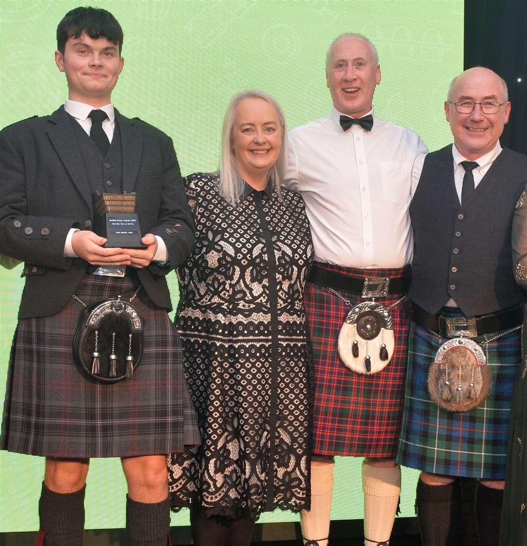 The Spar Scourie team at the awards ceremony. Business partners Innes MacDonald and Andy Mackenzie are third and fourth left while Andy’s grandson Charlie Macrae, who works in the shop, is holding the award. Sam Urquhart, second left, is shop manager. Picture: Scottish Grocer Awards