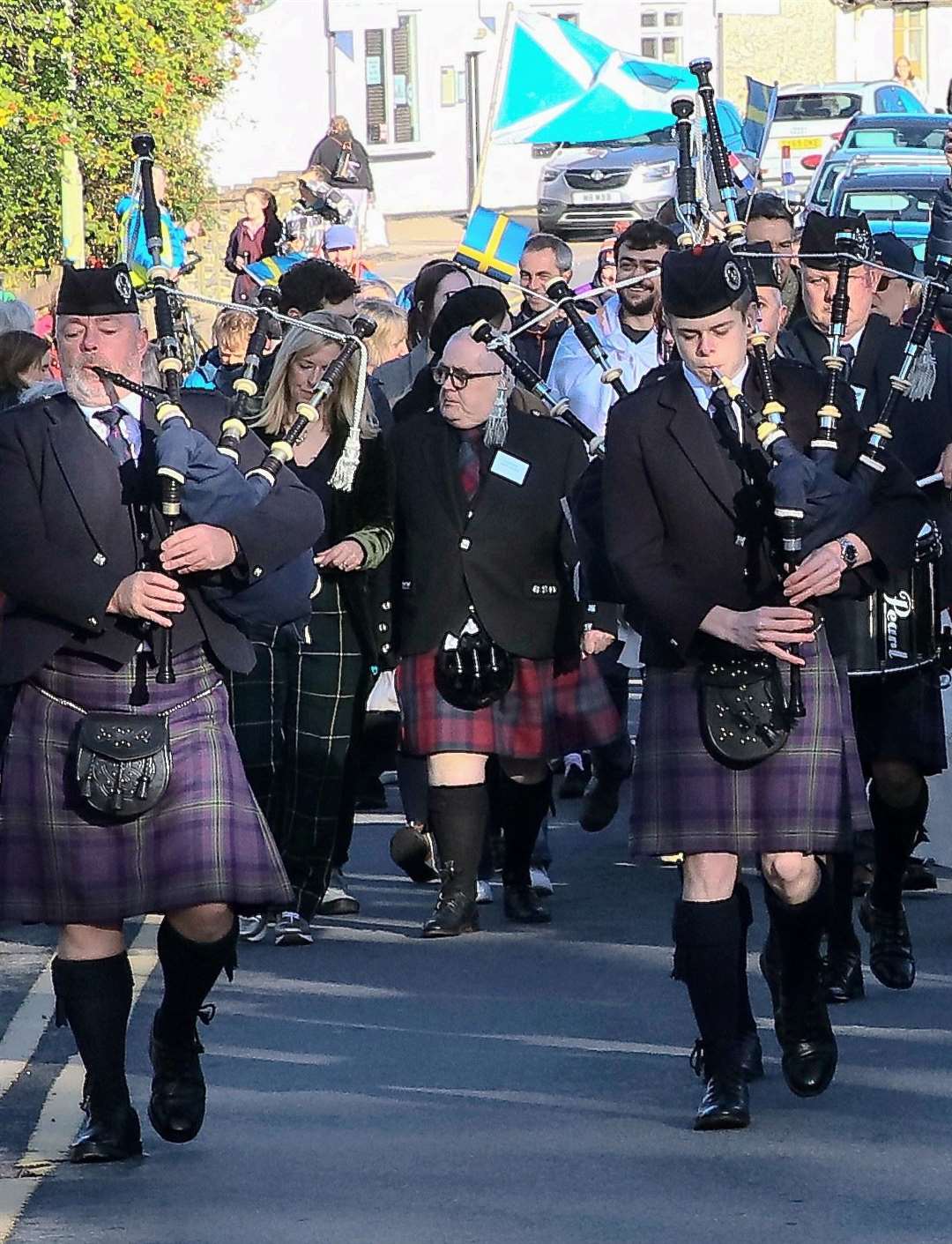 Charlie is their darling: joining the big parade at Carrbridge at one of the world championships is chieftain Charlie Miller (centre)