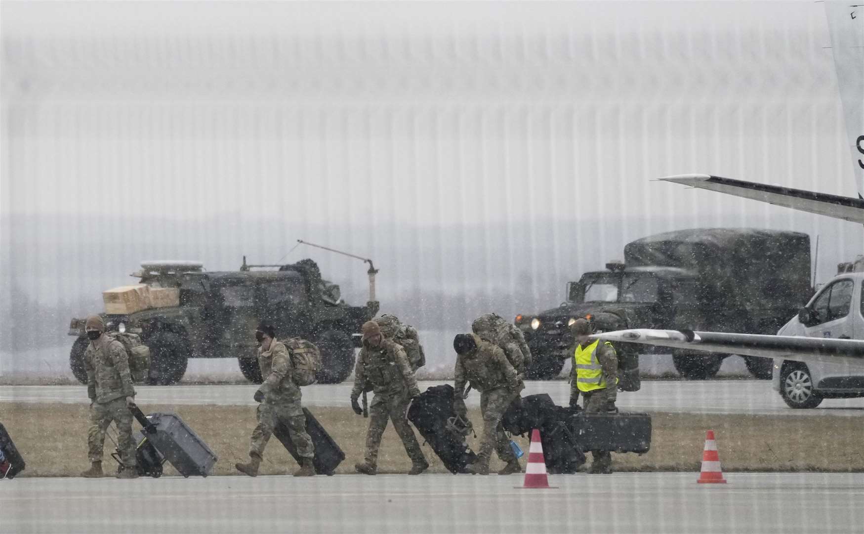US army troops unloading vehicles from a transport plane after arriving in south-eastern Poland, on Sunday (Czarek Sokolowski/AP)