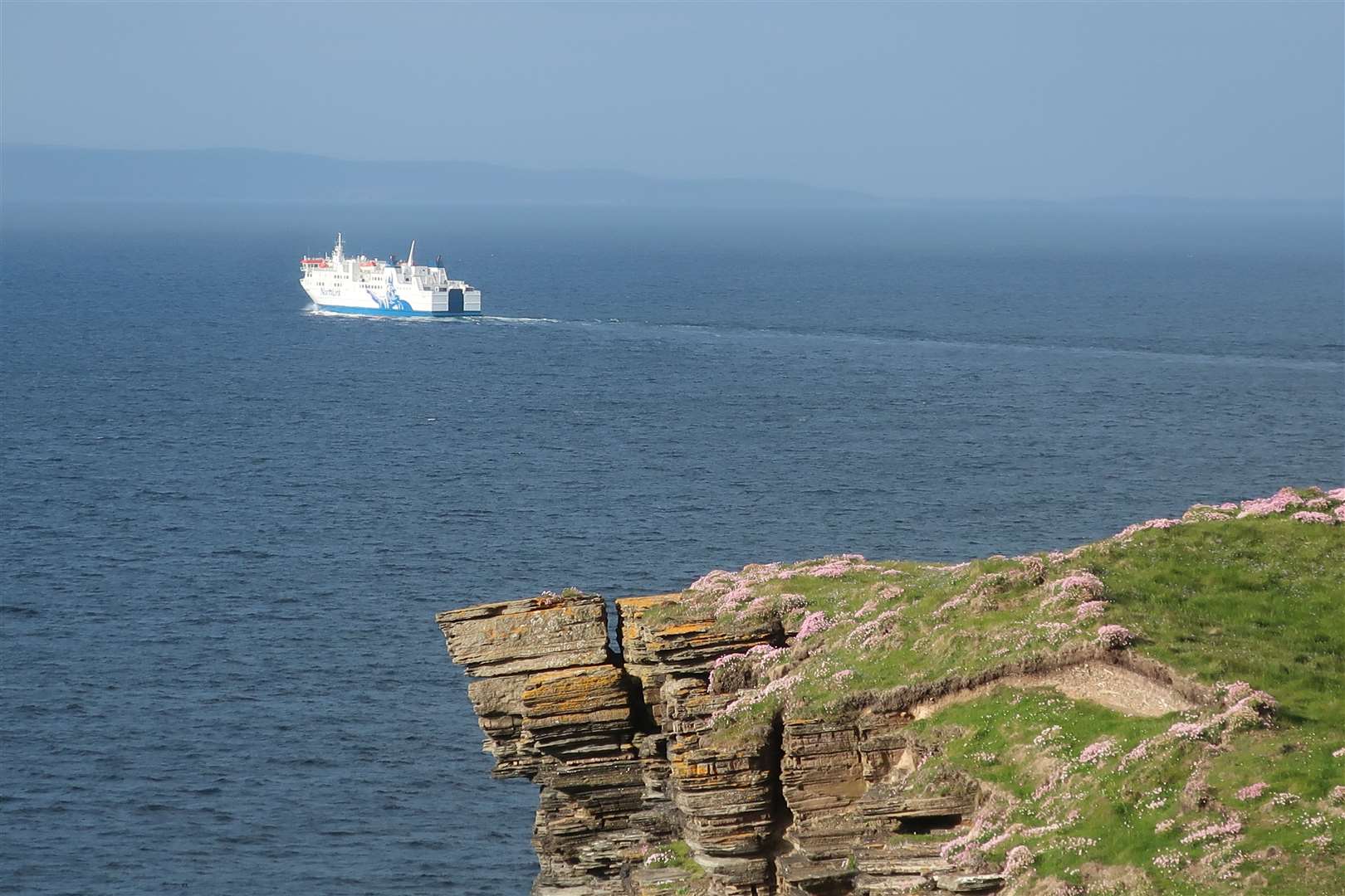 The NorthLink ferry heads out of Thurso Bay towards Orkney, as seen from Holborn Head.