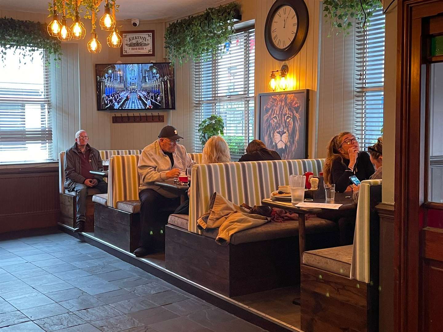 Customers inside The Lion watching Queen Elizabeth’s state funeral (PA)