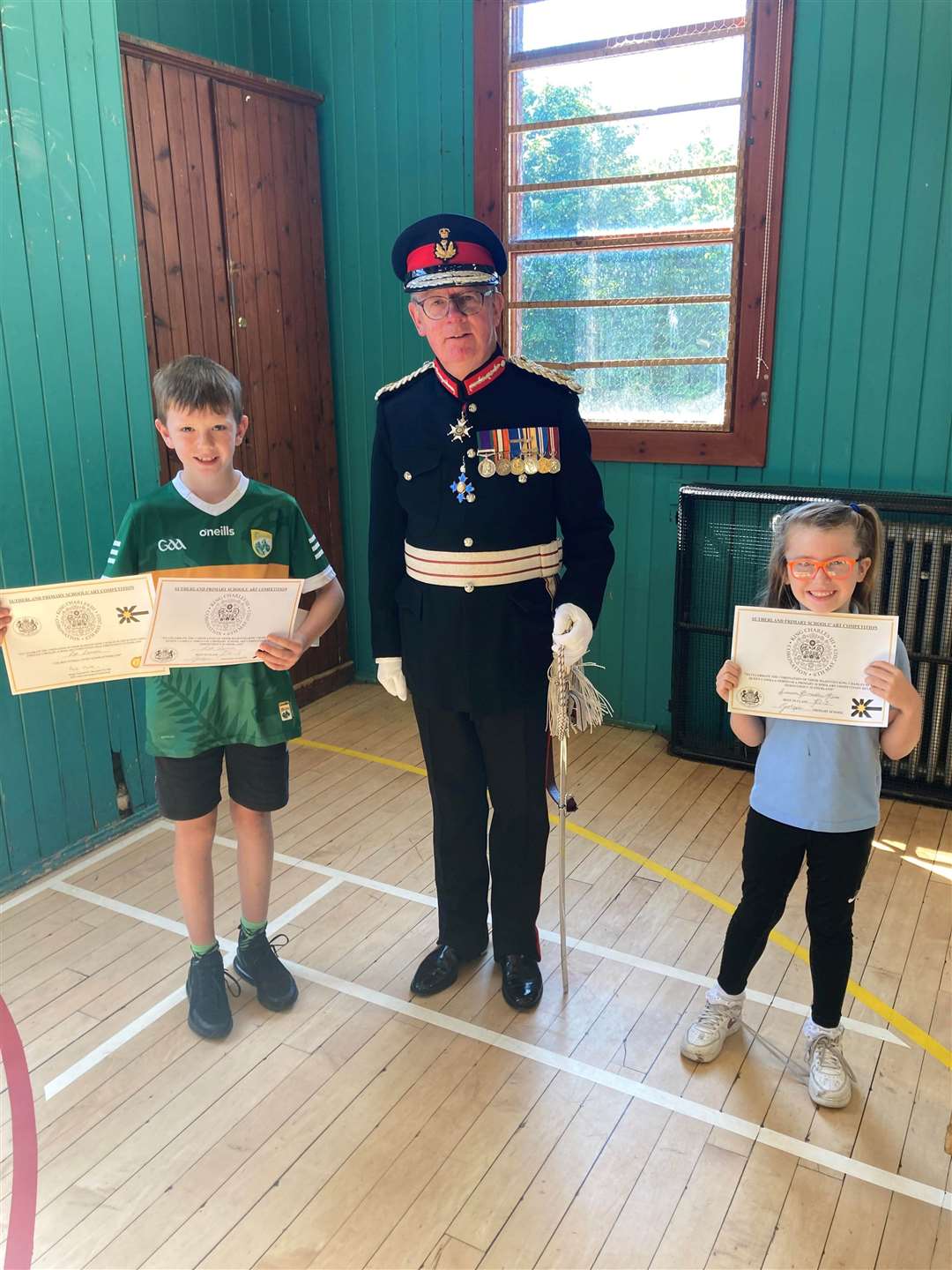 Lord Lieutenant Patrick Marriott at Golspie Primary School with overall winner of the competition Leo Lannon and Summer Bradley-Rice, winner of the P1-3 class. Alba Sutherland took first place in the nursery class.