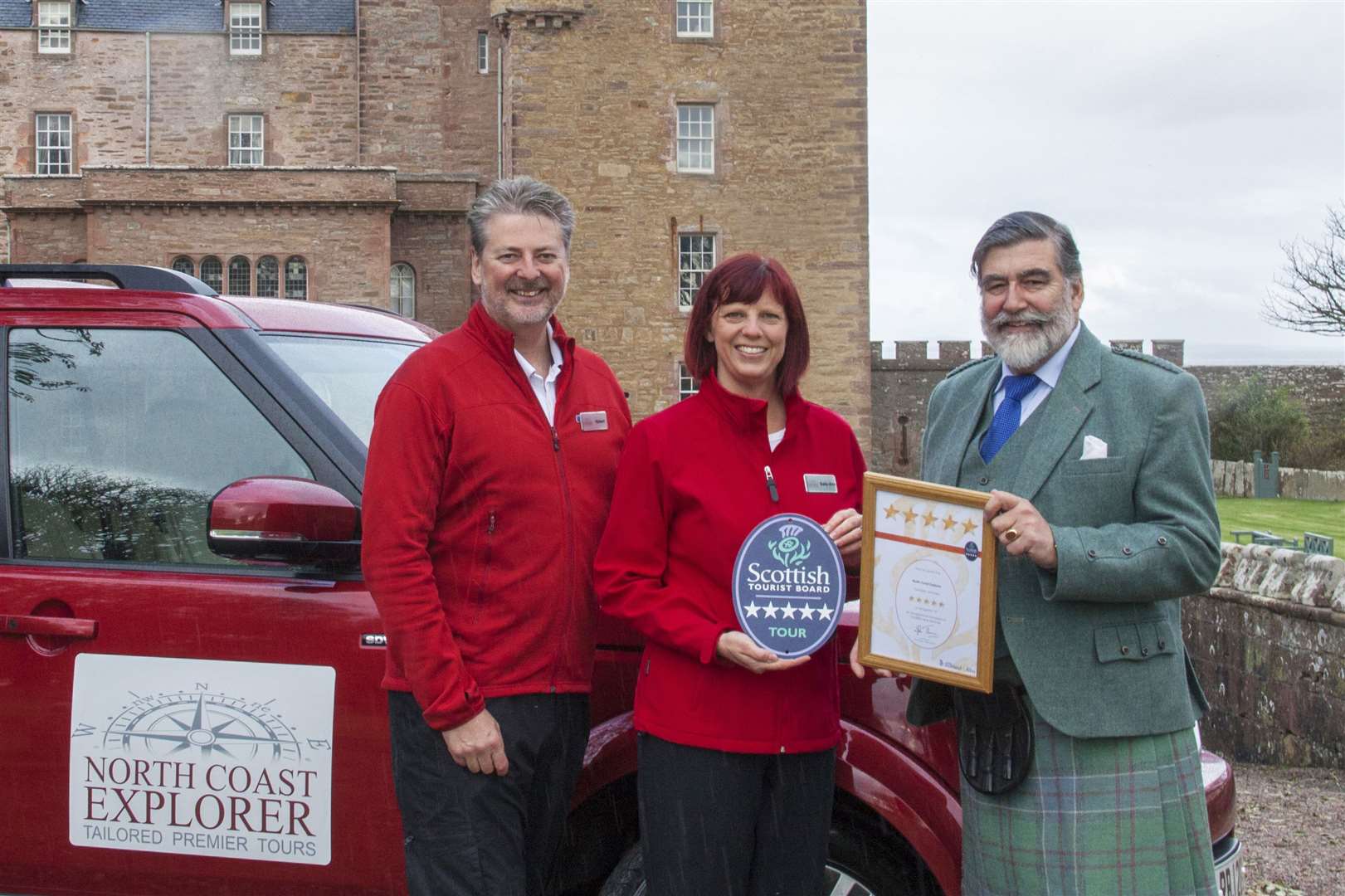 VisitScotland chairman Lord Thurso presents the Quality Assurance Award to Robert and Sally-Ann James of North Coast Explorer Tours.