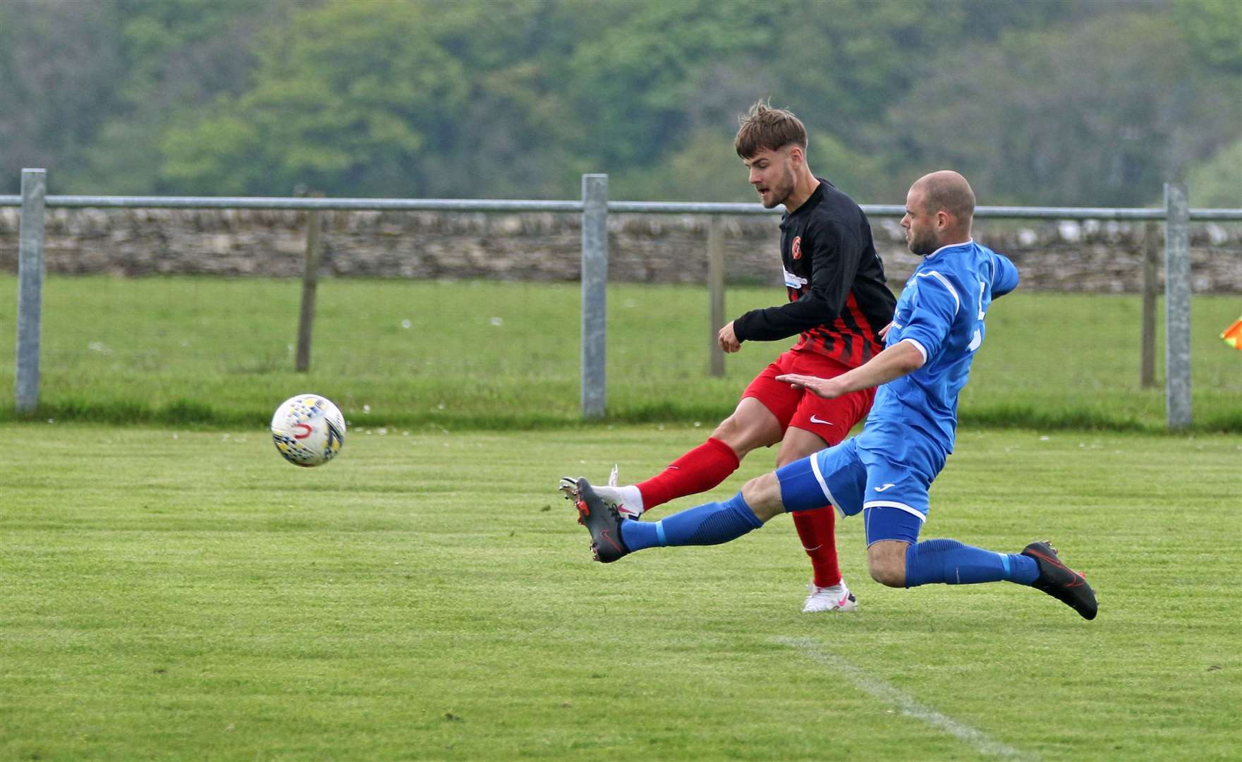 Halkirk United forward Jonah Martens fires a shot past the outstretched Sean Munro of Golspie but it was off target. Picture: James Gunn