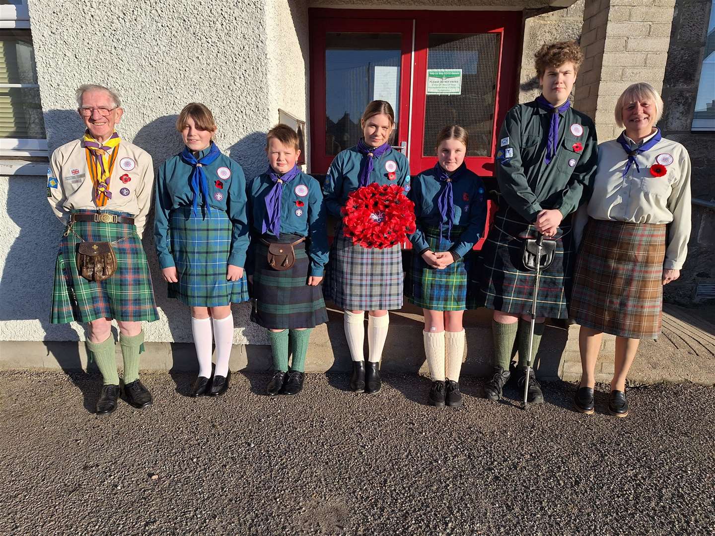 Members of the 1st Brora Scout Group took part in the parade and laid a wreath on behalf of the organisation. From left, Scout leader Davy MacDonald, Katie Smith, Kyle Smith, Isla Hirst, Rachel Drain, Mathieu-luc Bellis, and Assistant Scout Leader Kath Rennox.