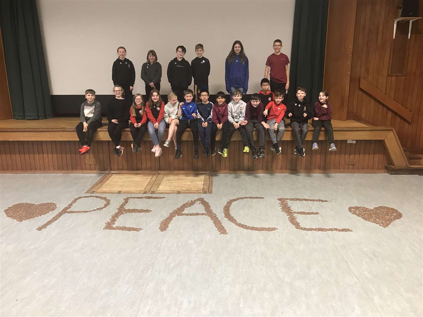 Pupils at Brora formed the word 'peace' with their collection along with two hearts.