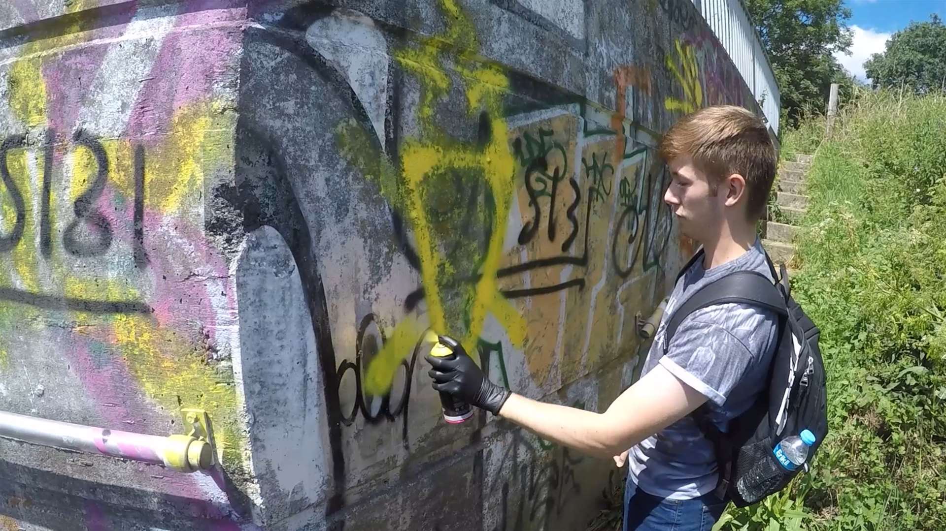 Ben Hannam, pictured spray painting graffiti, was jailed for four years after becoming the first officer to be convicted of NA membership (Met Police/PA)