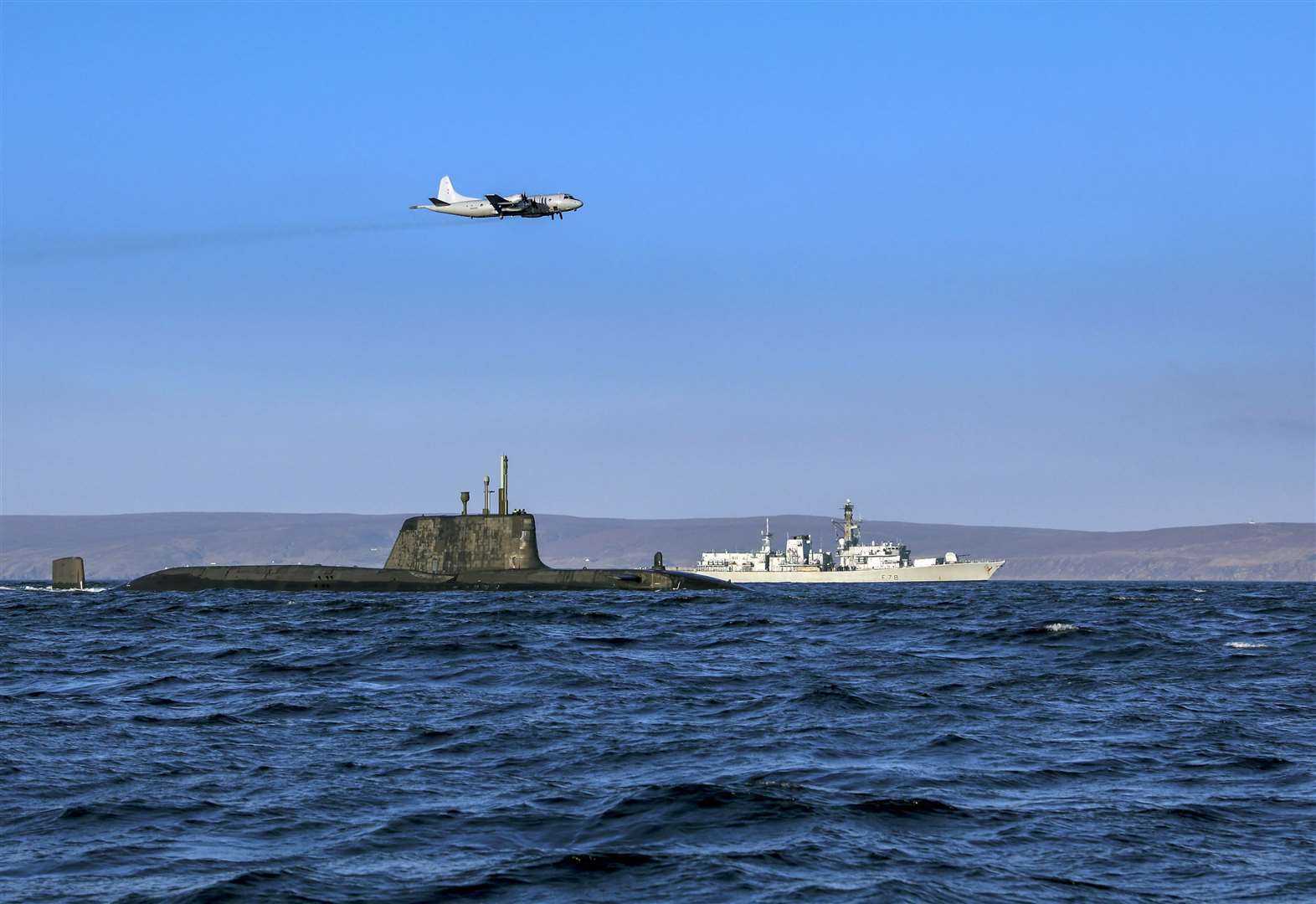 An Astute class nuclear submarine in company with the Type 23 frigate HMS Kent being over flown by a German Navy P3 maritime patrol aircraft during a previous operation Joint Warrir exercise.