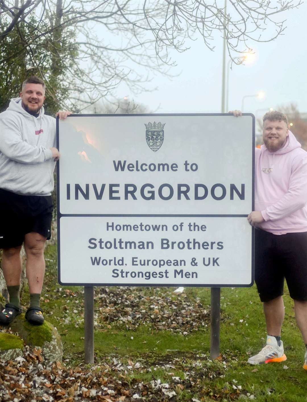 The Strongman Stoltman brothers at the new Welcome to Invergordon sign made in their honour: Luke Stoltman, Europe's Strongest Man and Tom Stoltman, UK's and World's Strongest Man, .  Pictured: James Mackenzie.