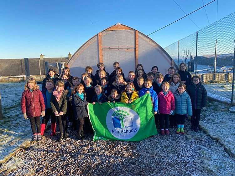 Melvich Primary school with their new Green Flag standing outside the new timber tunnel. Picture: Melvich Primary School.