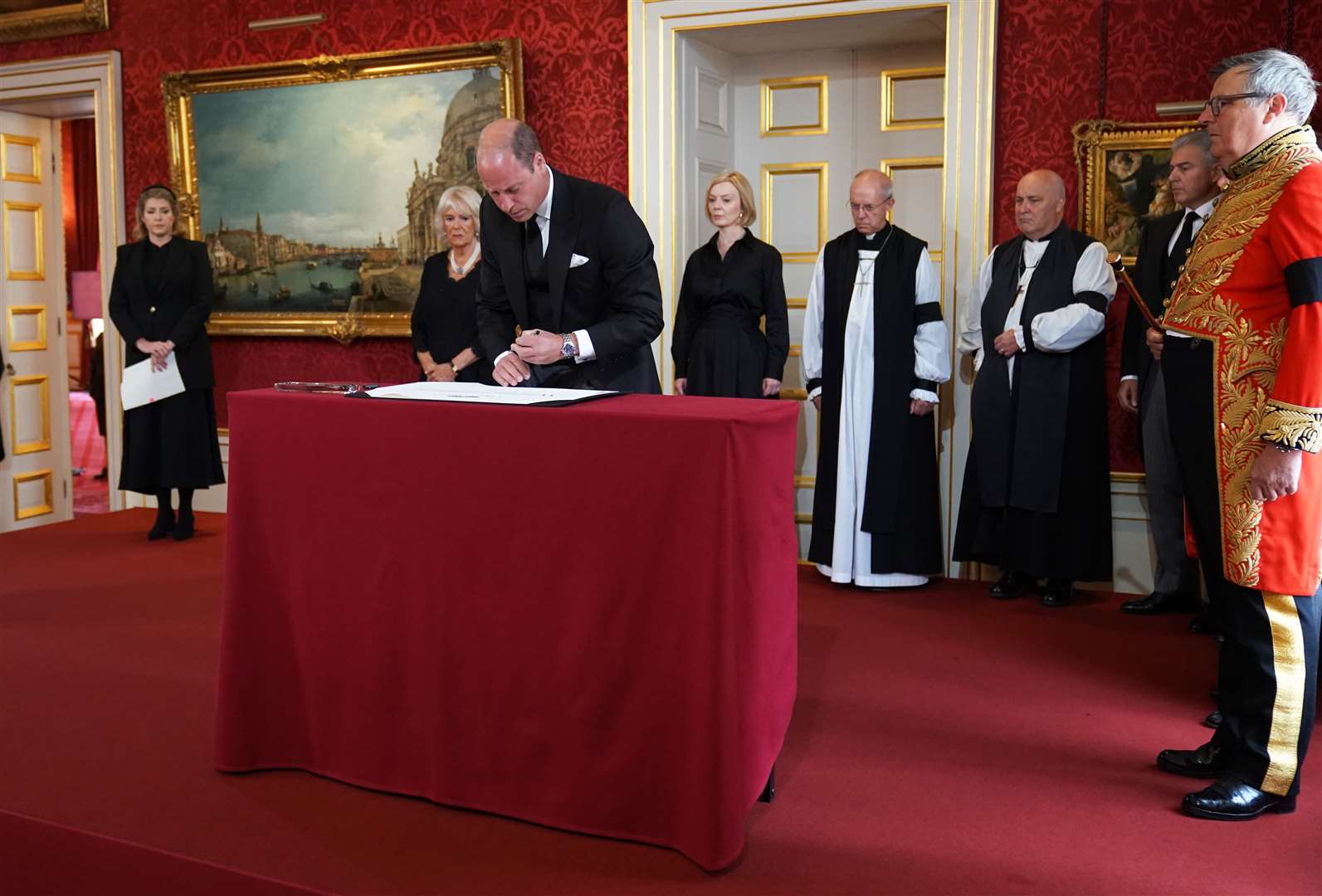 Earl Marshal, Edward Fitzalan-Howard, the Duke of Norfolk, on the right, watches as the Prince of Wales signs the Proclamation of Accession of King Charles III (Kirsty O’Connor/PA)