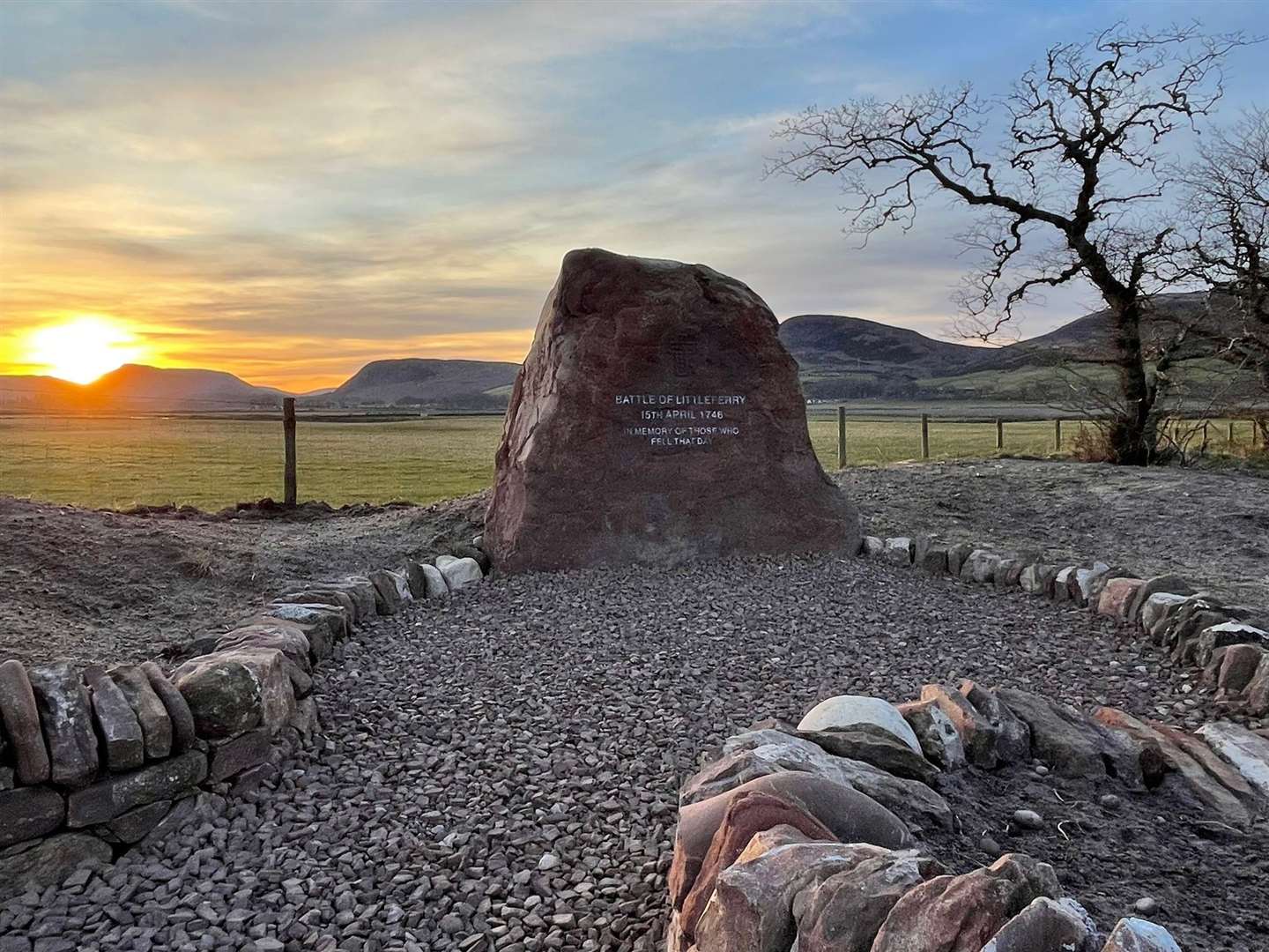 Littleferry battle memorial stone at sunset.