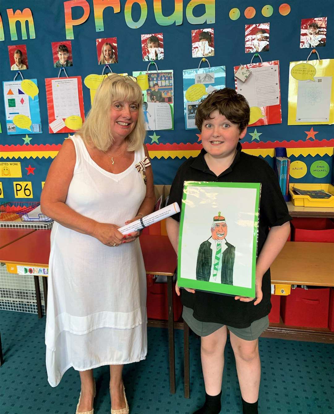 Rogart Primary School pupil Ennis Walker receives his p4-7 winner's certificate from Vice Lord-Lieutenant Kim Tulloch.