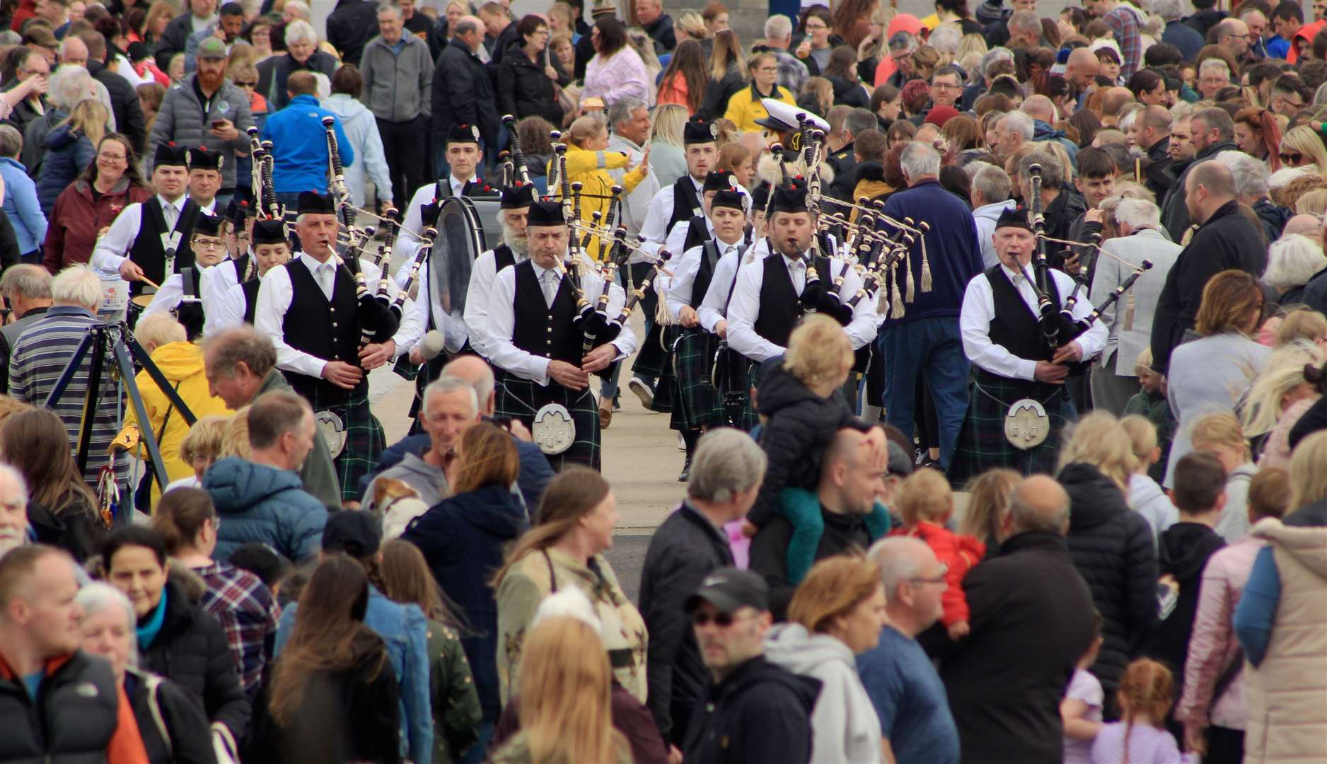 A crowded quayside durng a performance by Wick RBLS Pipe Band. Picture: Alan Hendry
