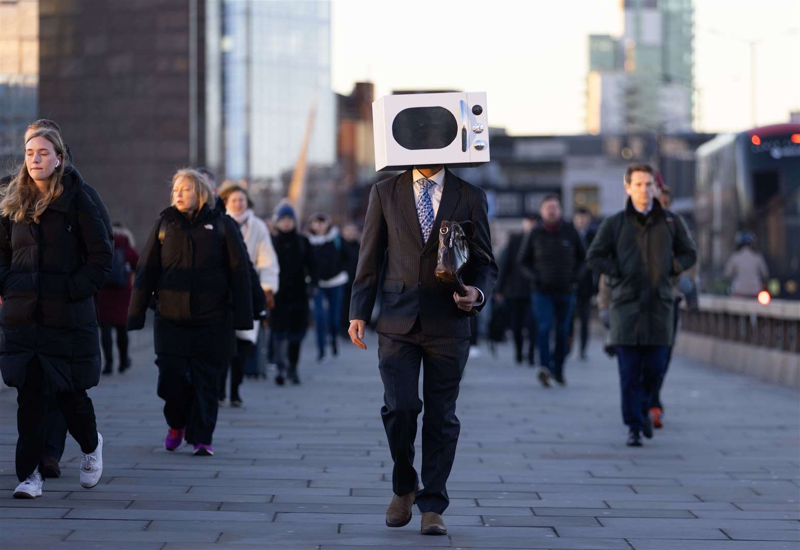 A man on London Bridge in central London with a microwave on his head (David Parry/PA)