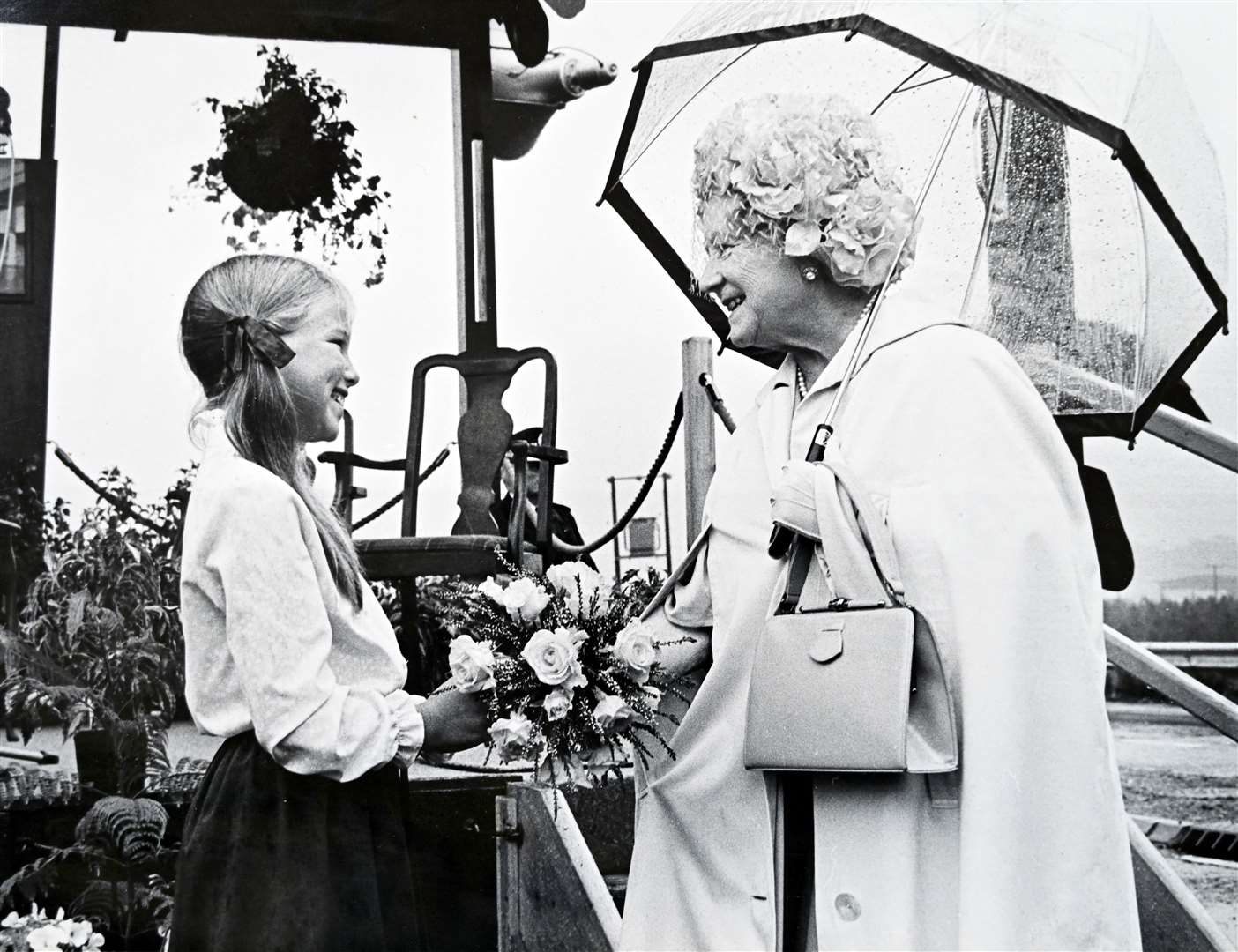 Julia Wilson presents flowers to the Queen Mother.
