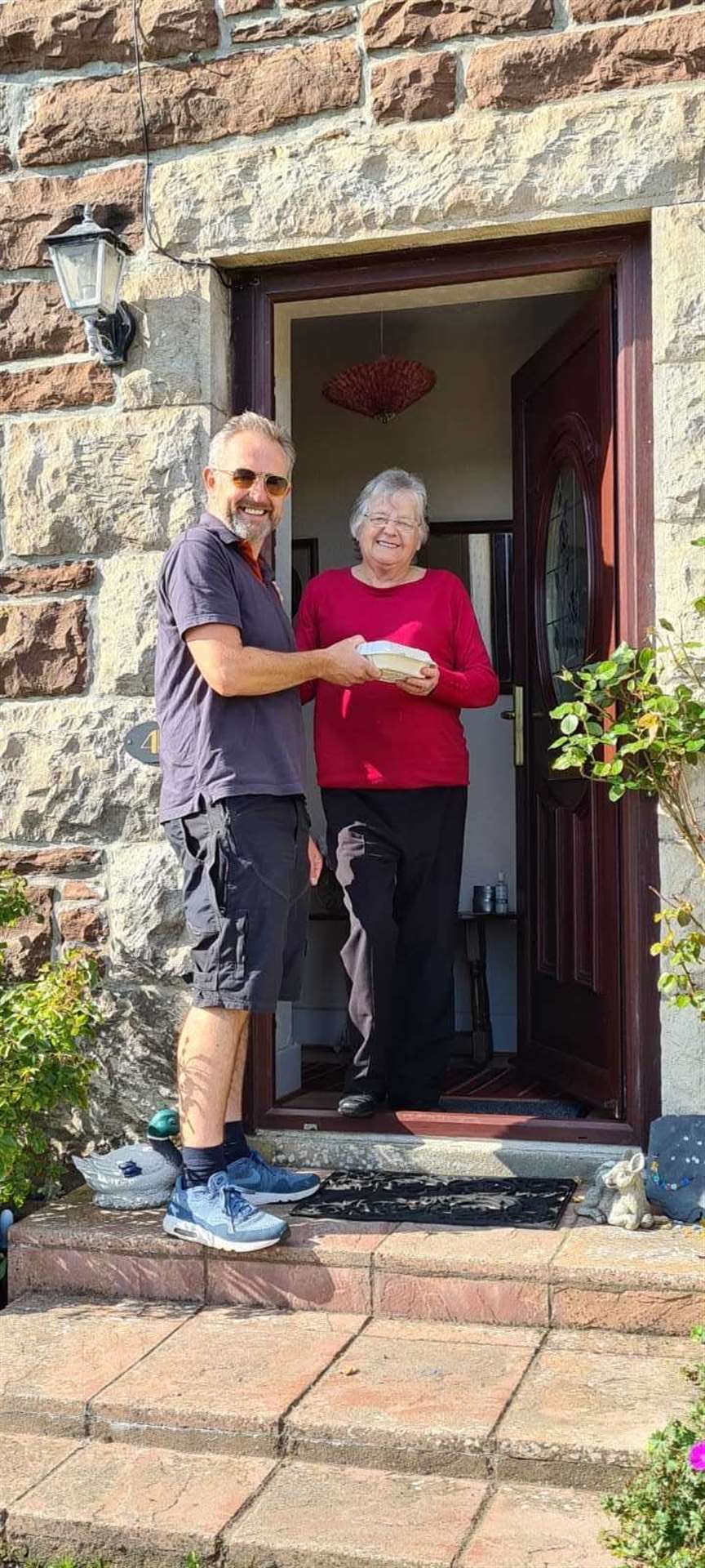 Ian Sutherland, of Go Golspie, delivers a fish and chip supper to Barbara Cumming.