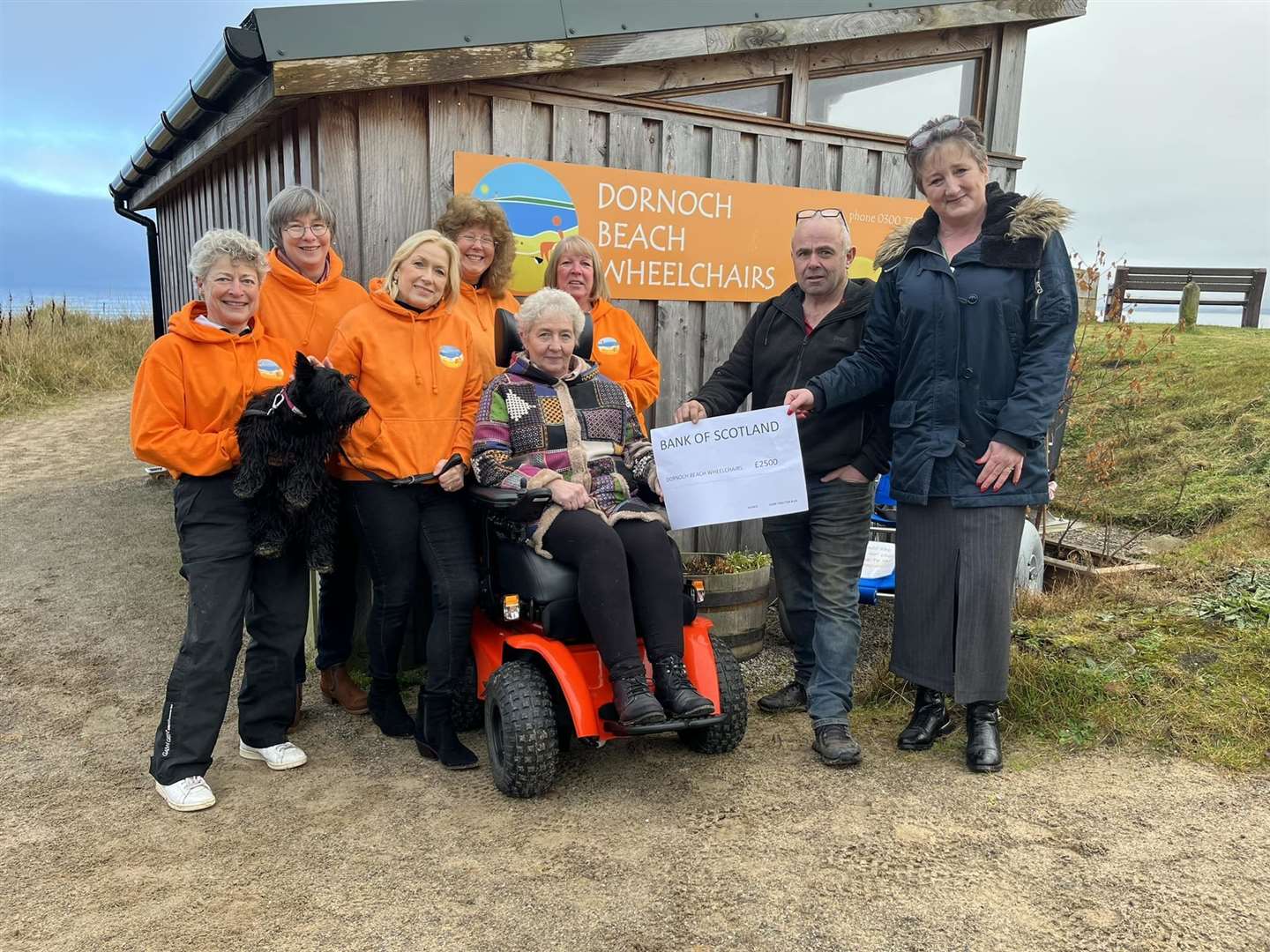 Catherine Macangus, right, hands over a £2500 cheque to Dornoch Beach Wheelchairs last November. The money was raised by the 2023 Gars Tractor Run.