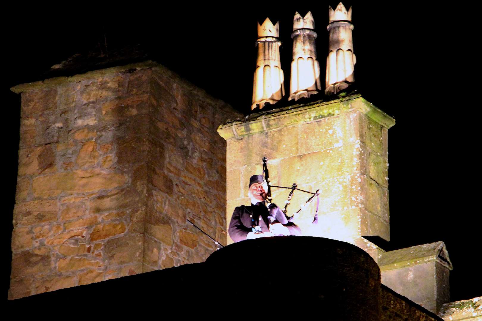 A lone piper plays from the battlements at Dornoch Castle.