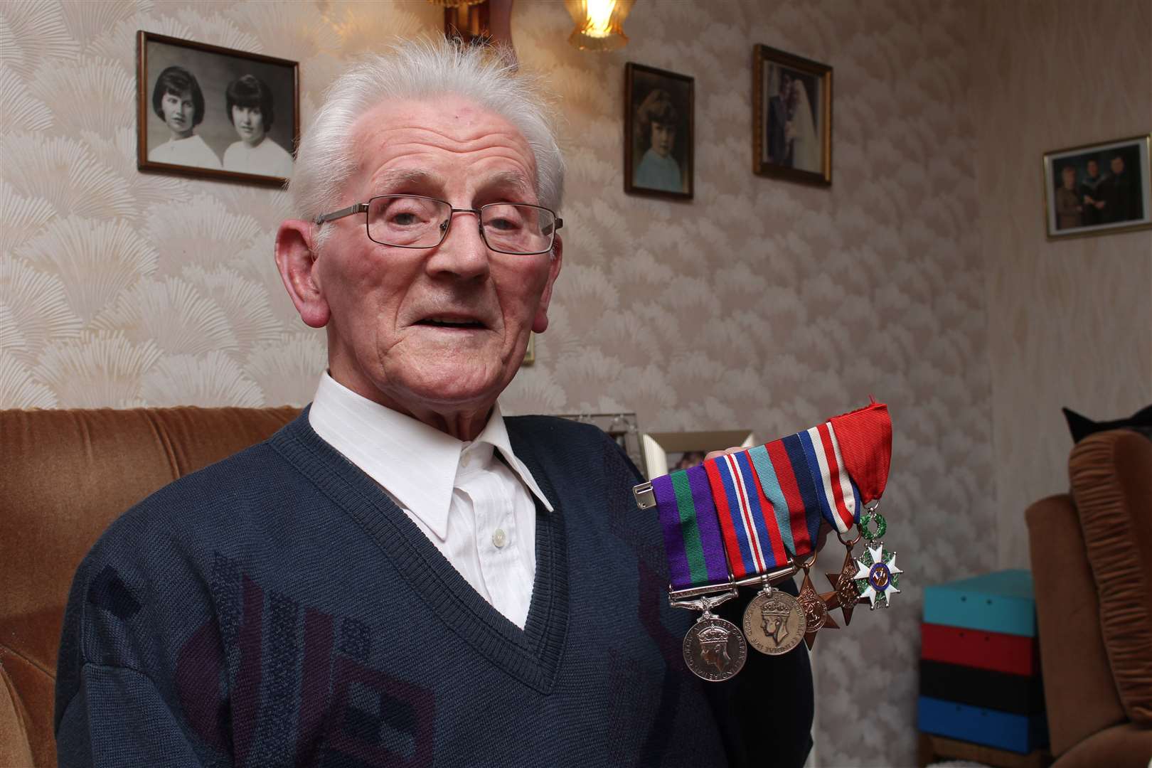 Robbie Larnach displaying his medals, including the Légion d'Honneur on the right.