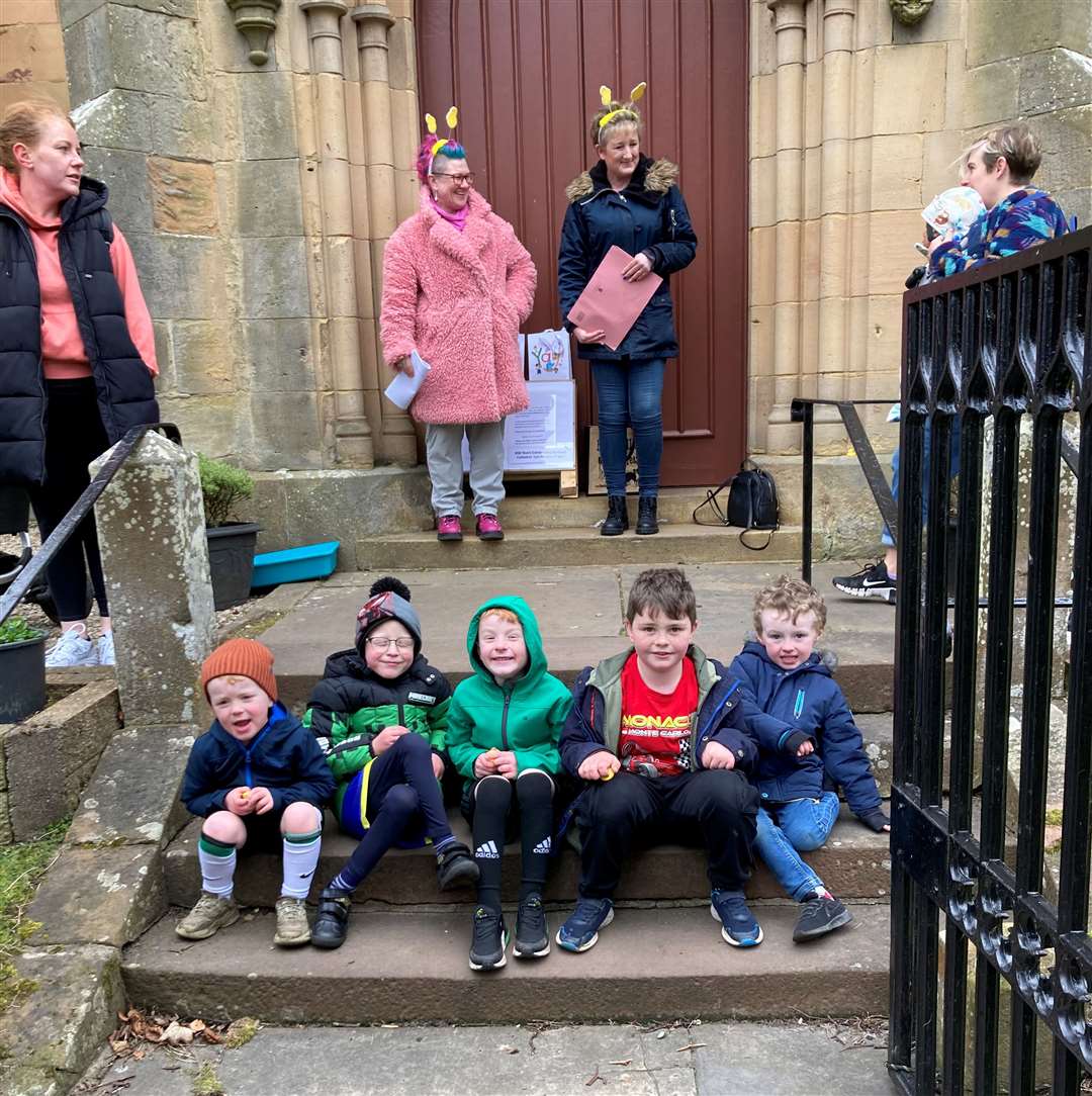 Smiling faces at the entrance to Dornoch Cathedral.