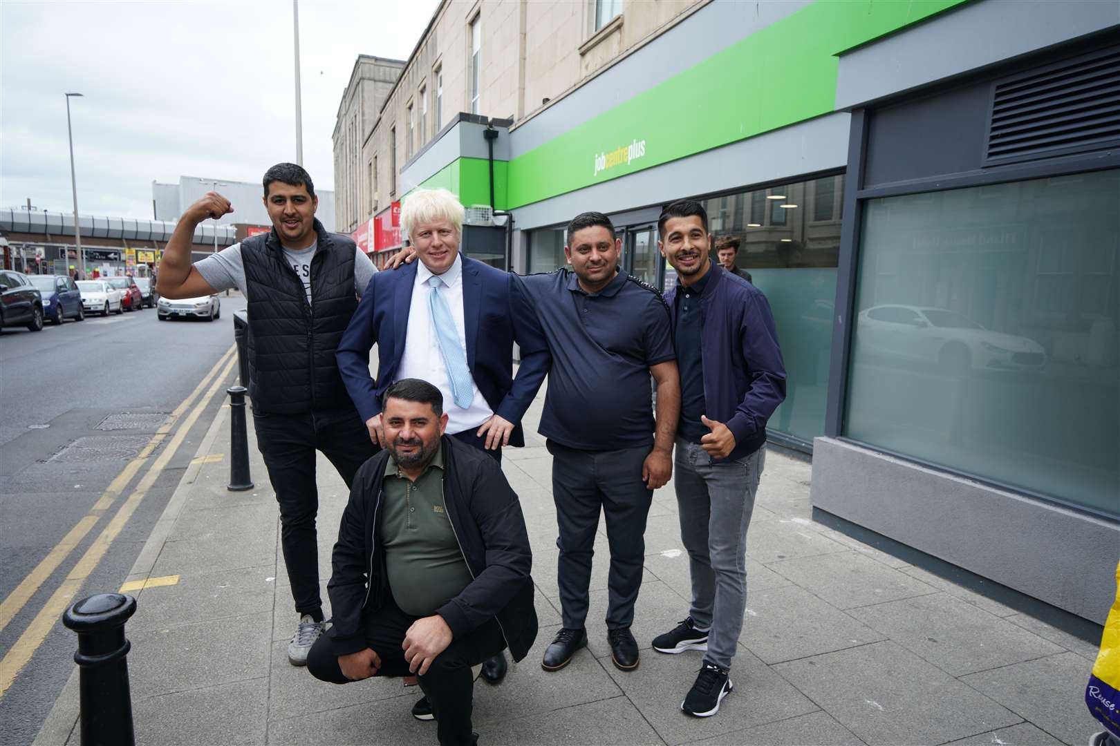 Members of the public pose with the wax figure of Boris Johnson (Peter Byrne/PA)