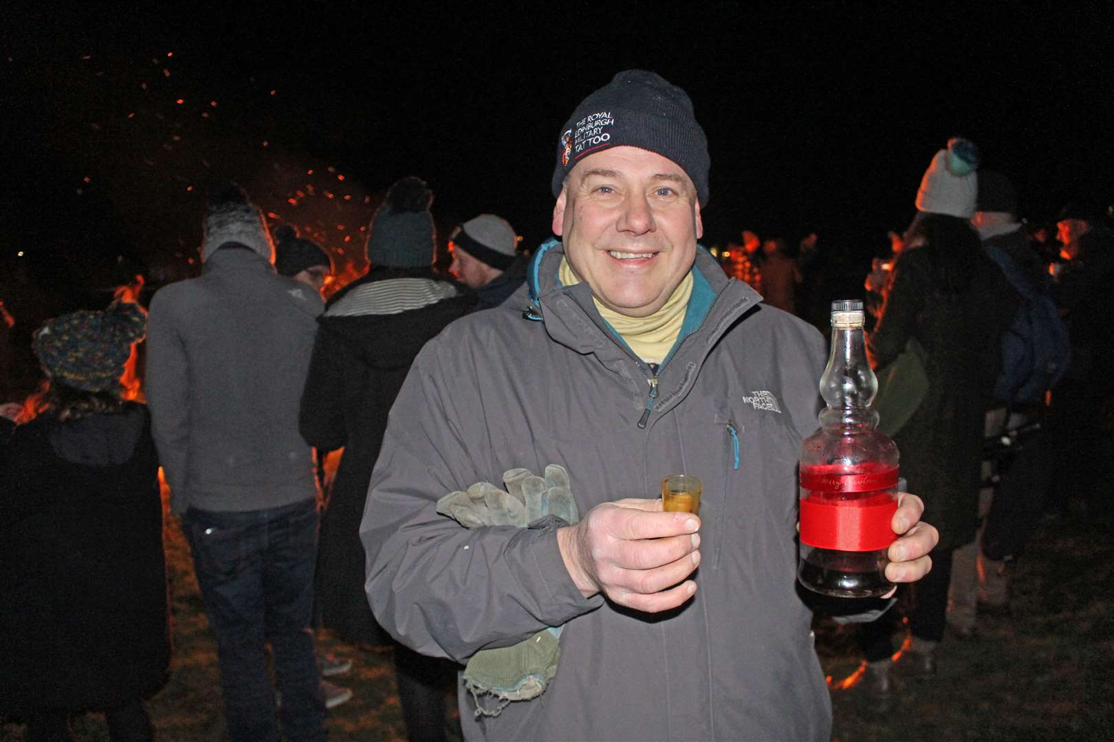 Organiser Mervyn Hill offering non-alcoholic ginger wine at last year's Hogmanay bonfire. Picture: Alan Hendry