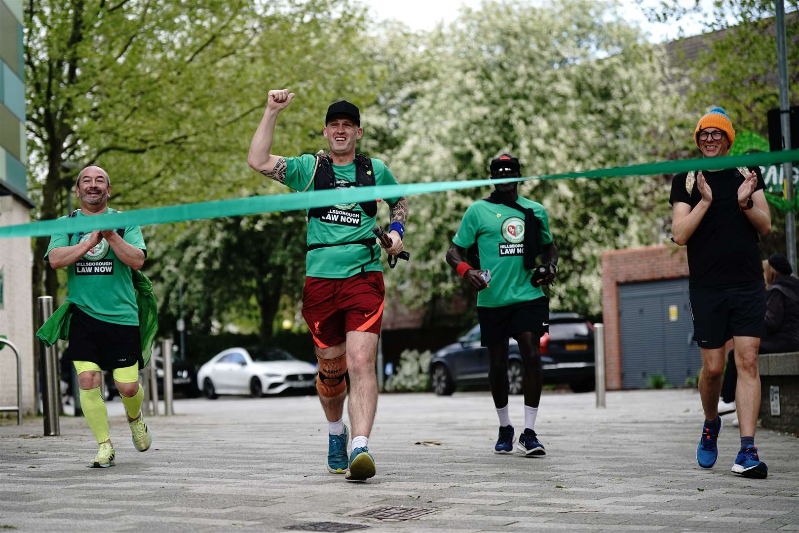Mik Parkin finishes his charity run at Grenfell Tower (Aaron Chown/PA)